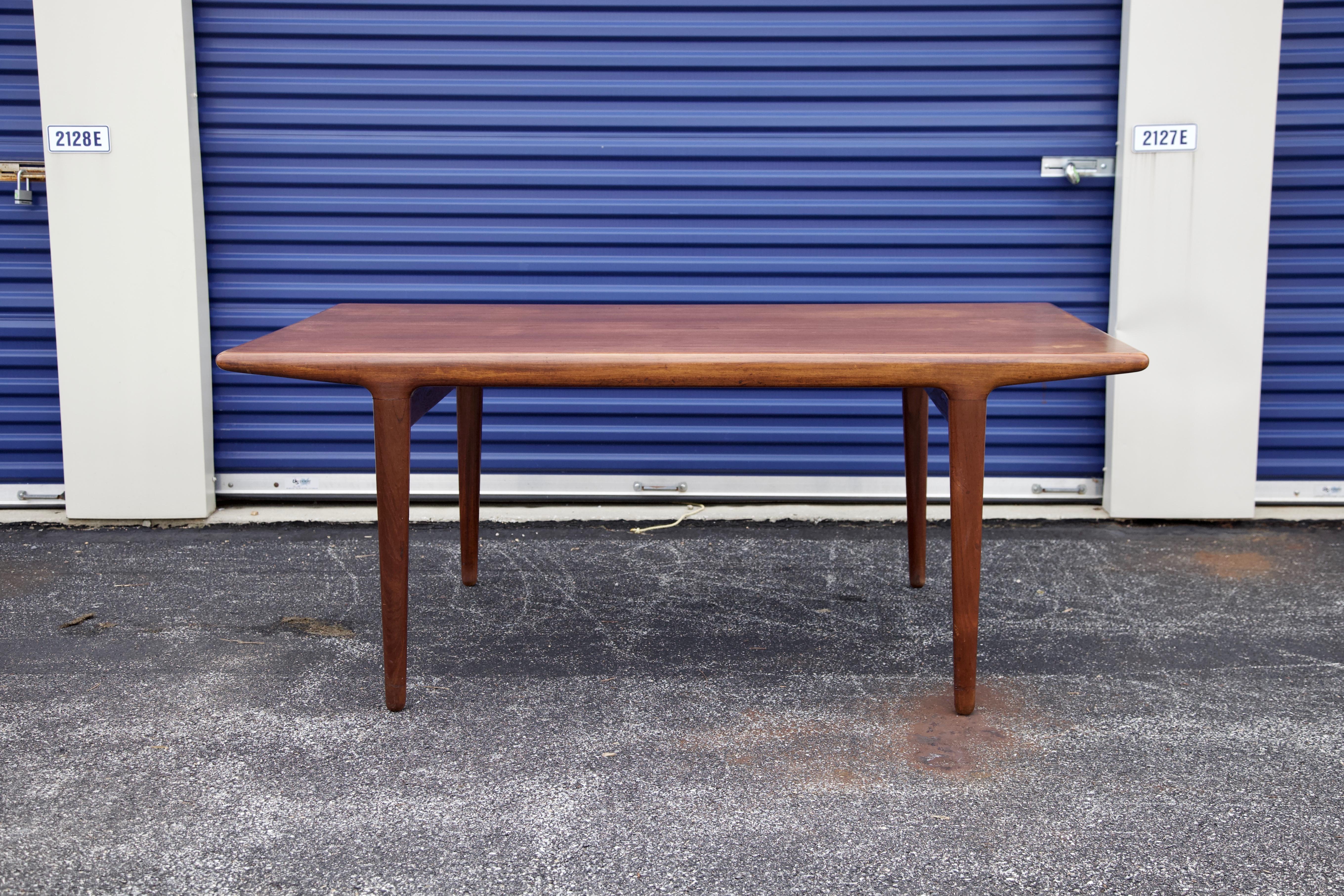 Niels Moller extendable dining table in teak, produced by J.L. Møller in Denmark, 1960s. There are two concealed leaves that easily slide out allowing the table to be extended with room for up to ten people. Each extension is 15.5inches. Stamped
