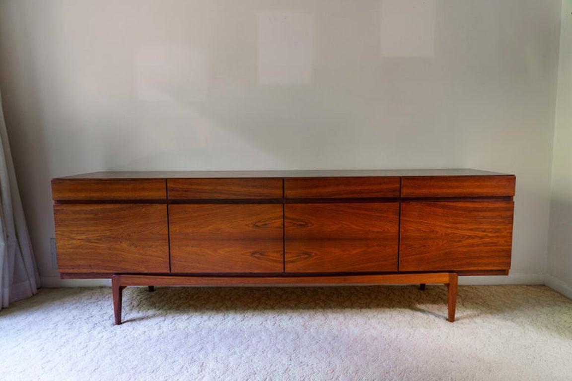 This stylish and chic Mid-Century Modern rosewood buffet dates to 1976 and was designed by Neils Moller

Note: The door on the far left-hand side has been restored along the back side (not the front edge of the door) see photo #11.

Note: This piece