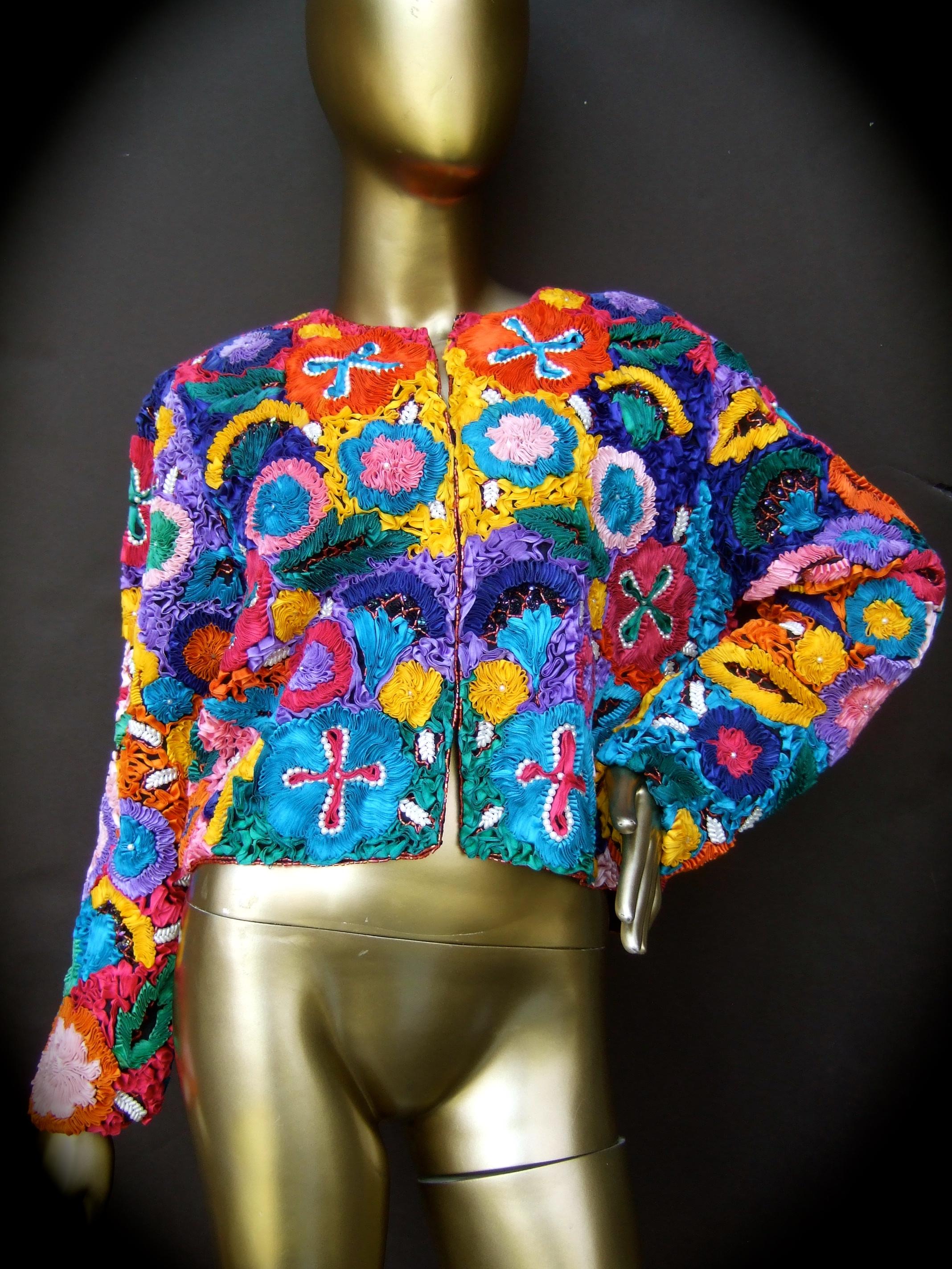 Neiman Marcus avant-garde pastel silk ribbon boxy bolero style jacket c 1990s
The unique jacket is designed with elaborate pastel silk pleated ribbon detail
in a myriad of vibrant  eye-catching colors 

The intricate ribbons have the texture of