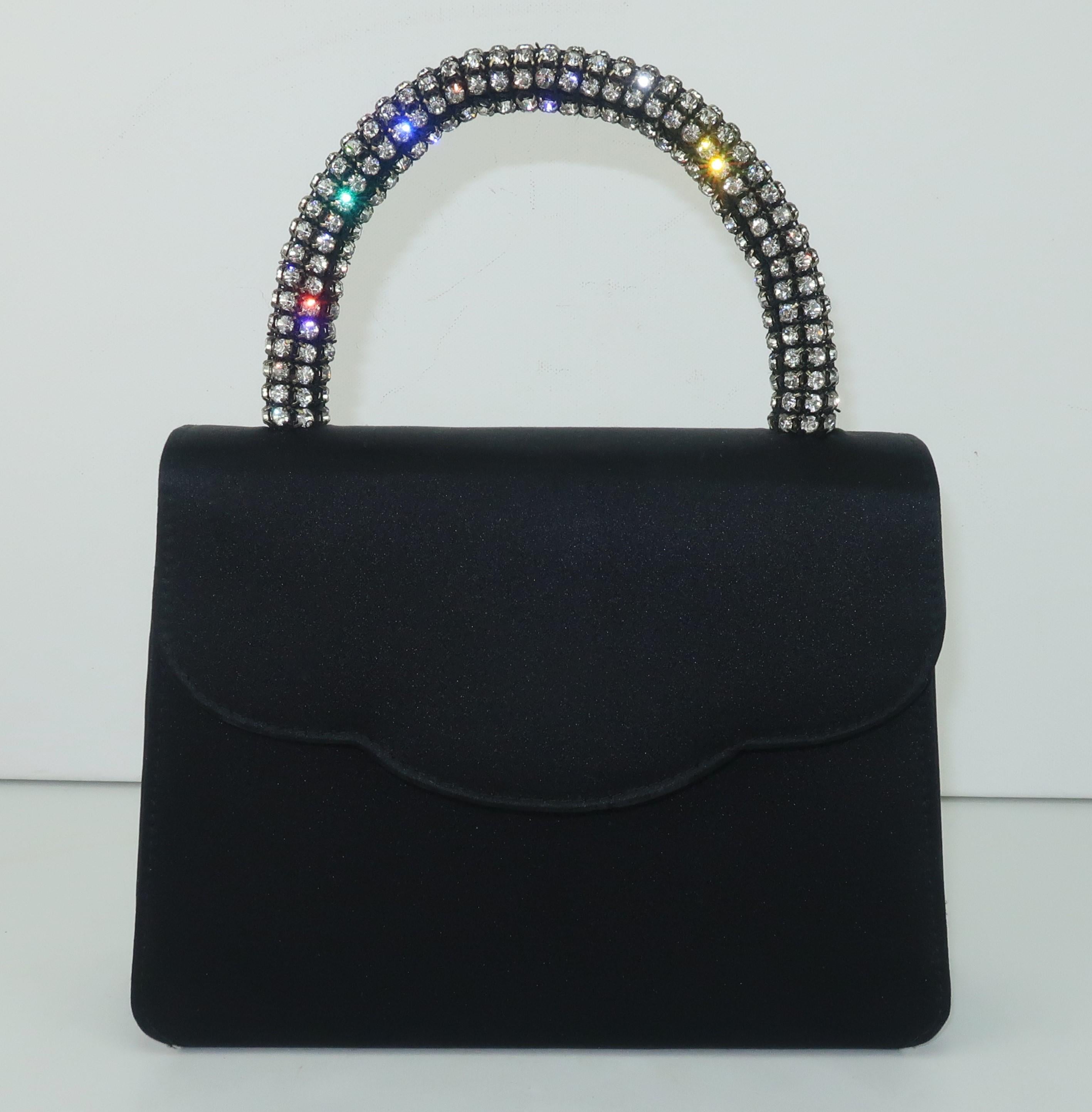 This is a wonderful little 'go to' evening handbag created by Neiman Marcus in a matte black satin fabric with a rhinestone rope top handle.  The classic silhouette is designed with glamorous vintage inspired details including a front flap closure