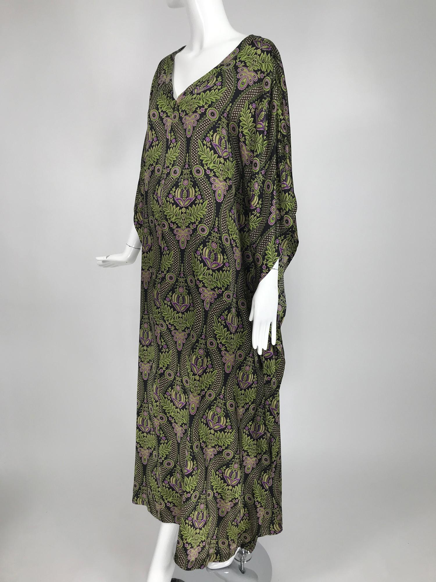 Neiman Marcus botanical printed silk satin caftan. Pull on caftan closes at the front with an invisible zipper. Beautiful and simple classic caftan style. Marked size XL.
     In excellent wearable condition.  All our clothing is dry cleaned and