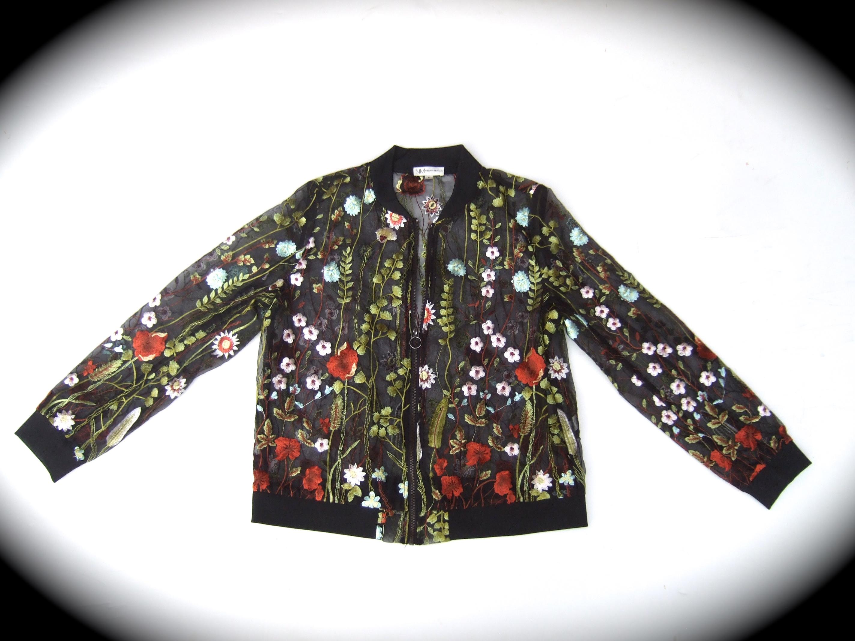 NEIMAN-MARCUS Floral embroidered sheer mesh zippered jacket Size Medium 
The field of vibrant flowers are illuminated against a sheer black see - through background
Zippers up the front with a silver tone metal zipper 

The collar, cuffs & waist