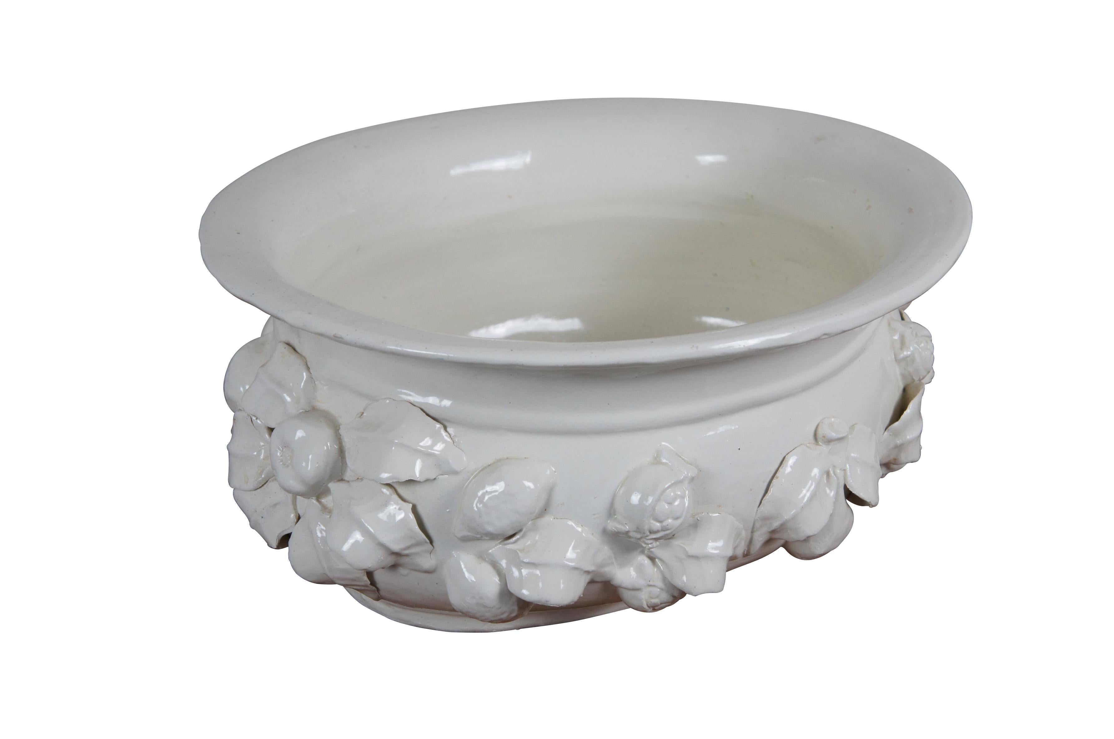 Late 20th century white glazed ceramic planter. Oval shape with flared rim, embellished with a garlands of leaves , pomegranates and lemons in high relief. Made in Italy for Neiman Marcus. Fruit centerpiece bowl, planter, flower pot, jardiniere,