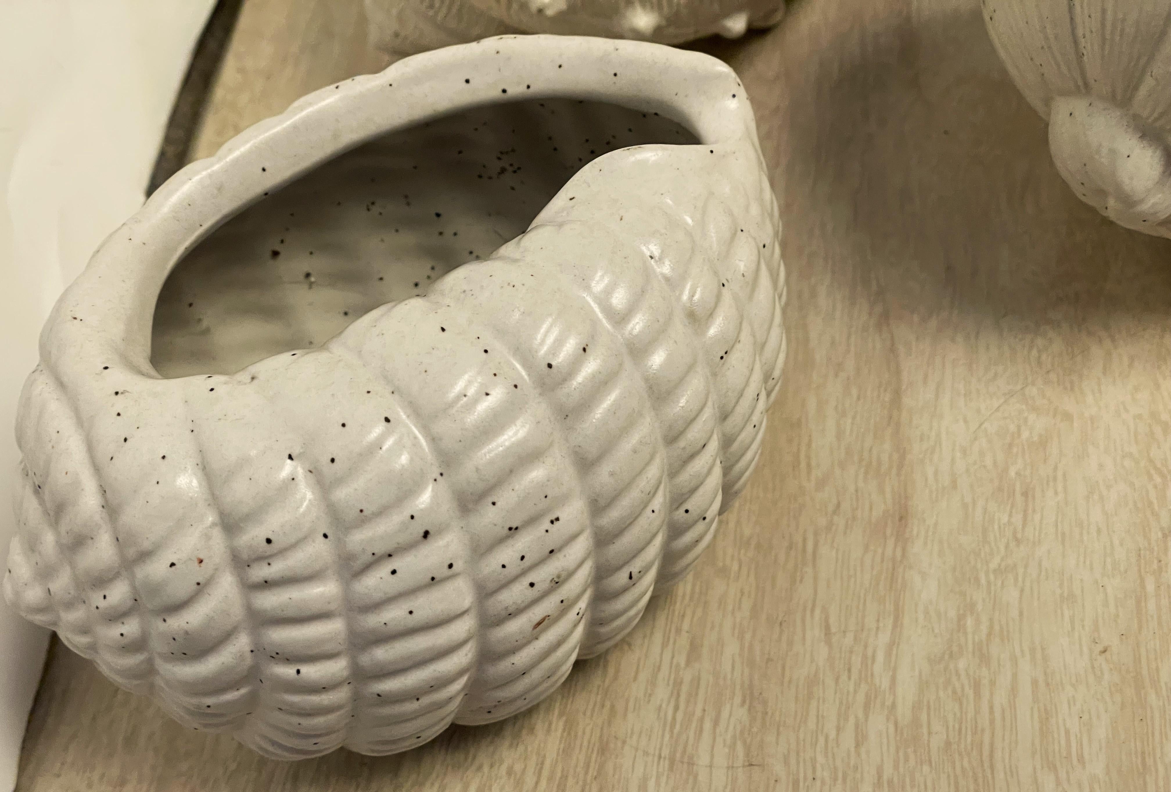 This is a wonderfully decorative set of four shell or snail shaped small planters which would be perfect for succulents or other small plants or would even be nice for displaying small collectibles such as marbles or crystals but are also fantastic