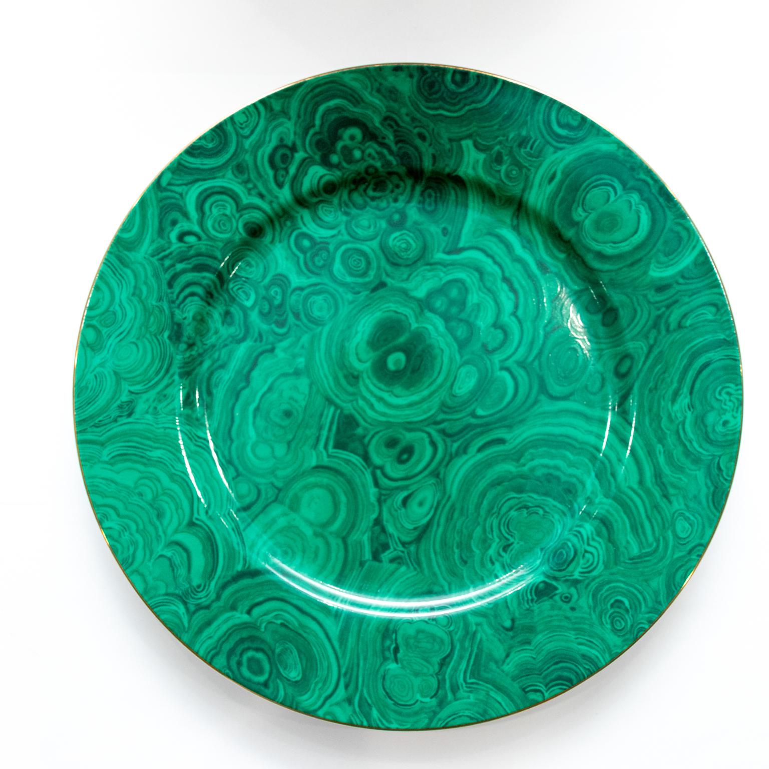 Circa 1970s Neiman Marcus vintage green and gold porcelain faux malachite plate chargers with a gold rim in the Mid-Century Modern style. The pattern has been discontinued and is a sought-after product collection. Please note of wear consistent with