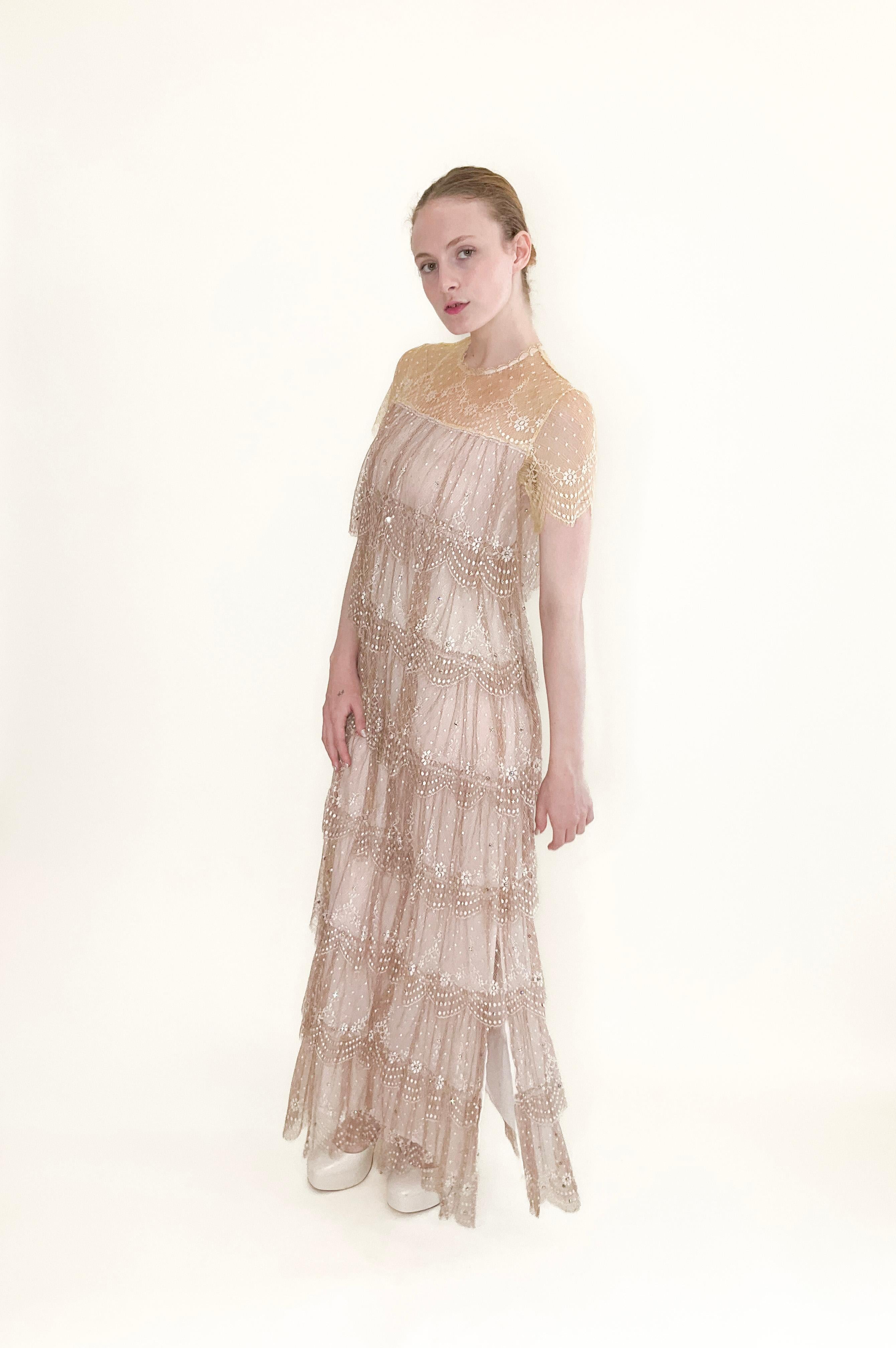 Effortlessly elegant and timeless, this Neiman Marcus gown features a delicate pastel yellow and dusty rose lace with intricate layers of ruffles. Adorned with sparkling rhinestones, this ankle-length gown is perfect for a daytime cocktail party or
