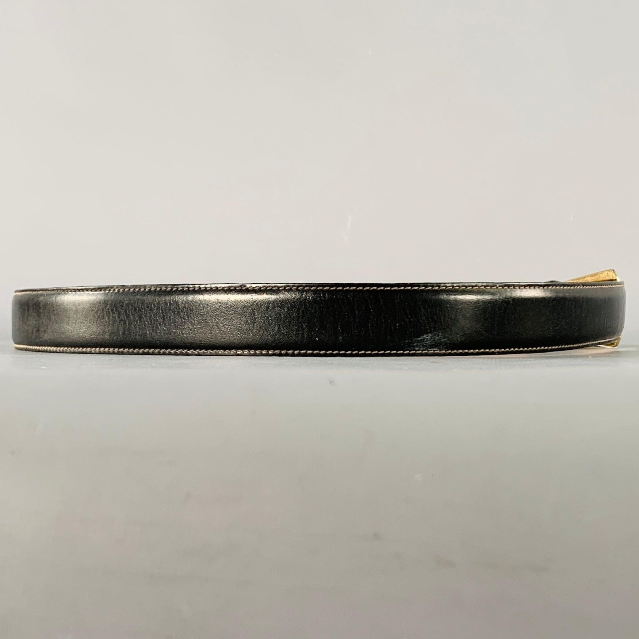NEIMAN MARCUS belt
in a black leather featuring a brass metal buckle.
Handmade by TRAFALGAR.Very Good Pre-Owned Condition. Moderate patina on buckle. 

Marked:   36Length: 41 inches Width: 1 inches Fits: 34 inches  - 37 inches Buckle: 1.5 inches 
