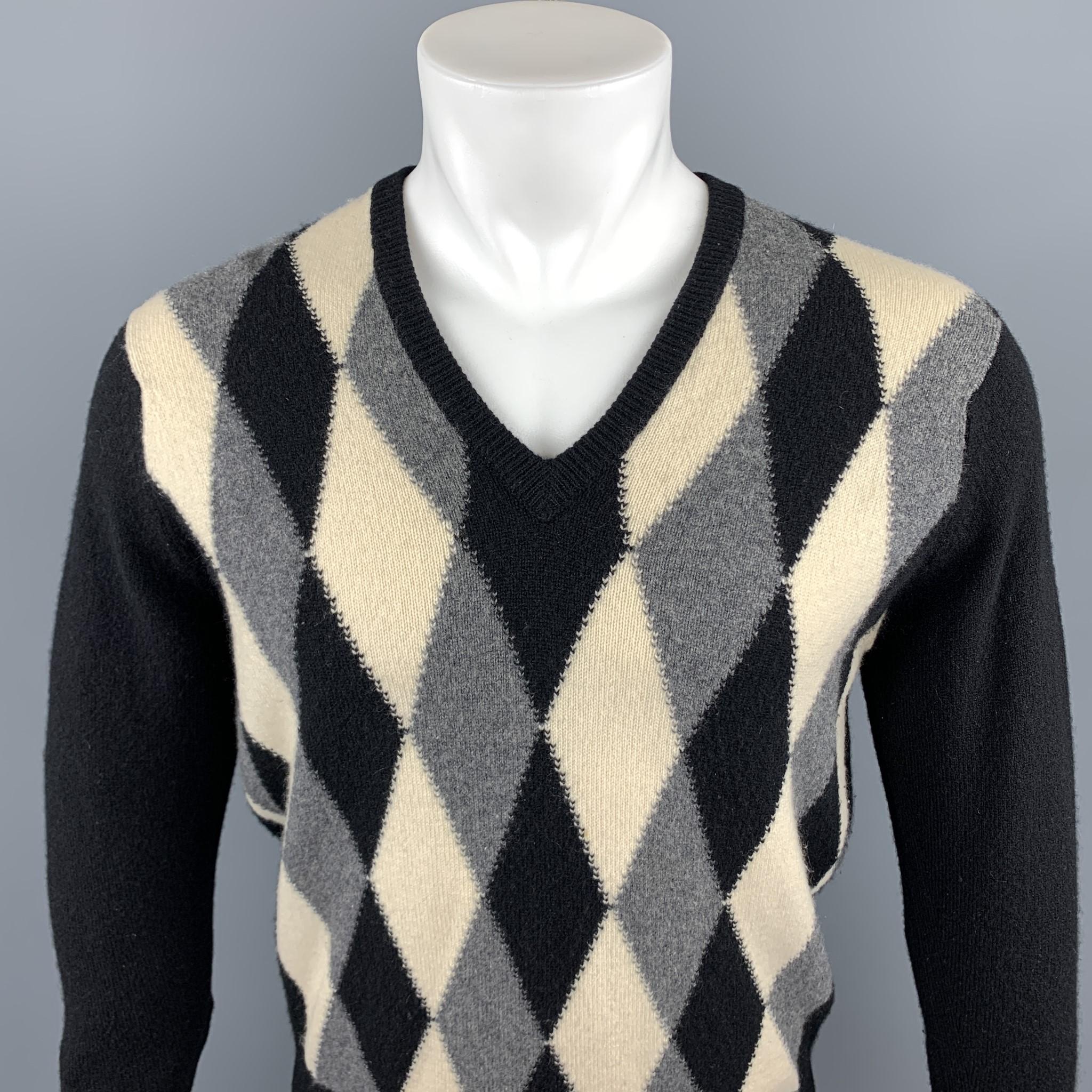 NEIMAN MARCUS pullover sweater comes in a black & gray argyle cashmere featuring a ribbed v-neck. Minor tear in the back of sweater. As Is. Made in Scotland. 

Very Good Pre-Owned Condition.
Marked: No Size Marked

Measurements:

Shoulder: 17.5 in.