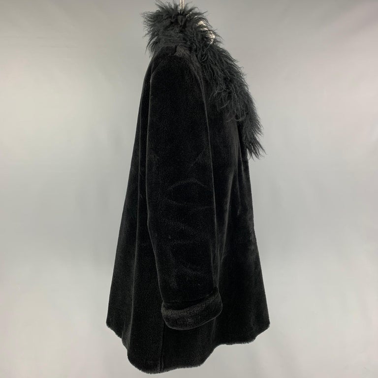 NEIMAN MARCUS coat comes in a black modacrylic faux fur featuring a large shawl collar, slit pockets, and a hook & loop closure. Made in USA.

Very Good Pre-Owned Condition.
Marked: M

Measurements:

Shoulder: 18 in.
Bust: 44 in.
Sleeve: 26