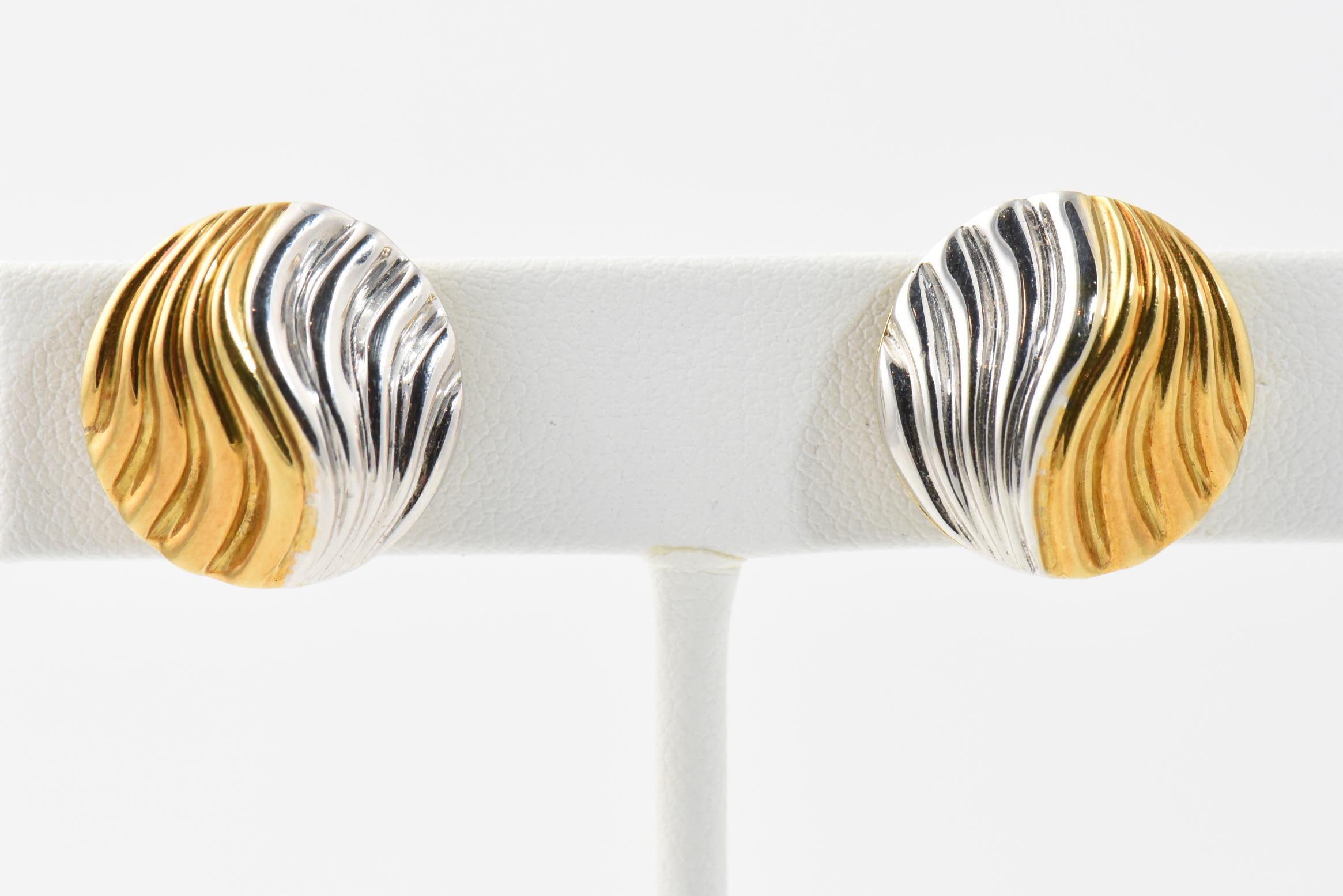 Italian 18K yellow and white gold earrings with three dimension textured wave surface marketed by Neiman Marcus. Clip backs (no posts). Marked: Neiman Marcus 750 Italy.
