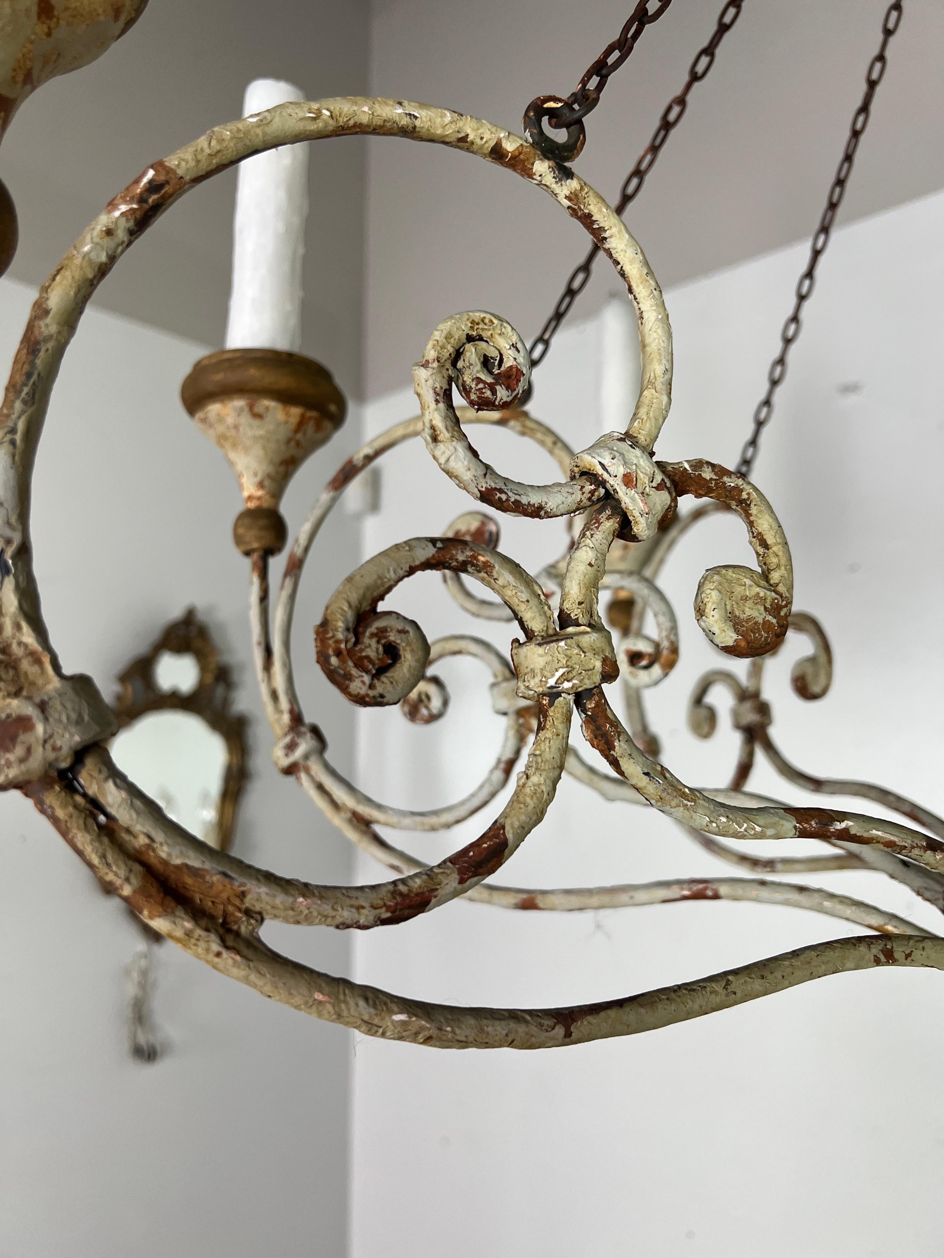 Eight arm painted iron & wood Neimann Weeks chandelier.  The iron is beautifully scrolled with wood painted bobeches.  The paint is weathered to perfection.  The fixture is newly rewired and includes chain & canopy.  Drip wax candle covers.