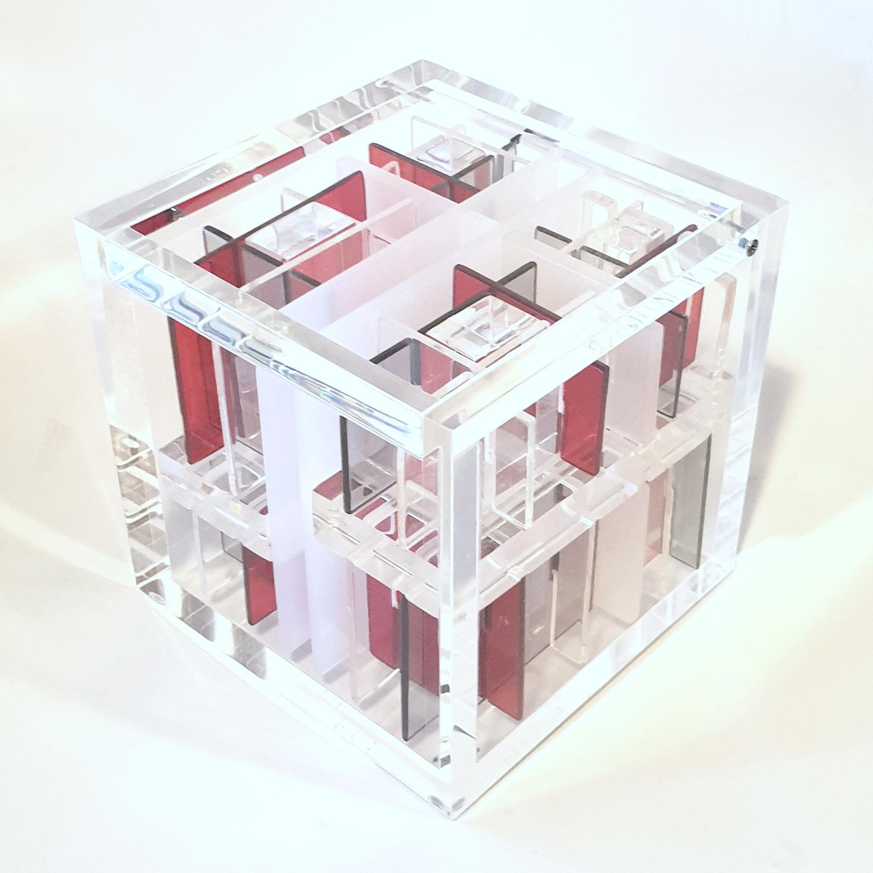 System Red-Grey is a unique small size contemporary modern cube sculpture by the famous Dutch artist couple Nel Haringa and Fred Olijve in which they explore the effects of opposite compositions in red, grey and transparent. Signature