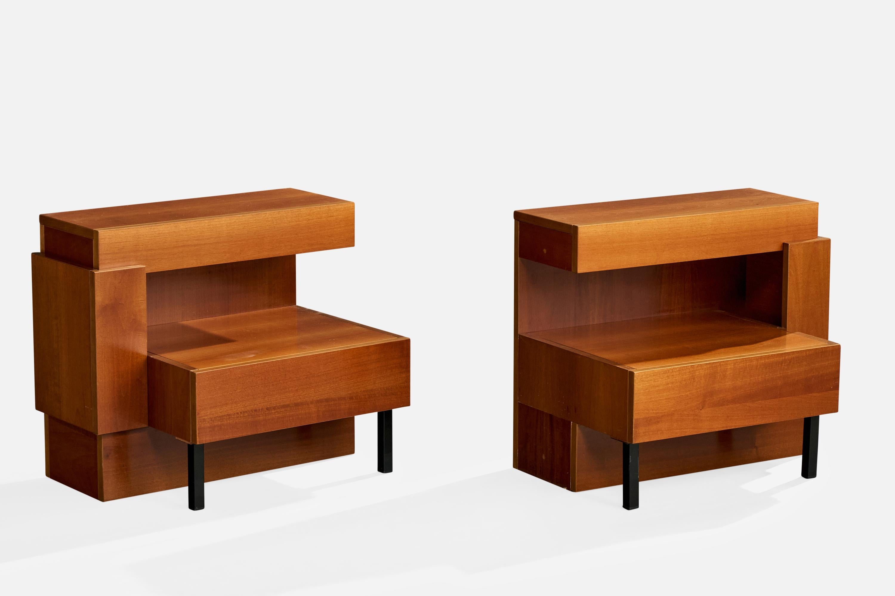 A pair of wood and black-lacquered metal nightstands attributed to Nello Baroni, Italy, c. 1960s.

Minor wear on wood and metal legs.

One has chipped veneer on bottom base edge.

Minimal wear inside drawers.

Unfinished outer back panels with