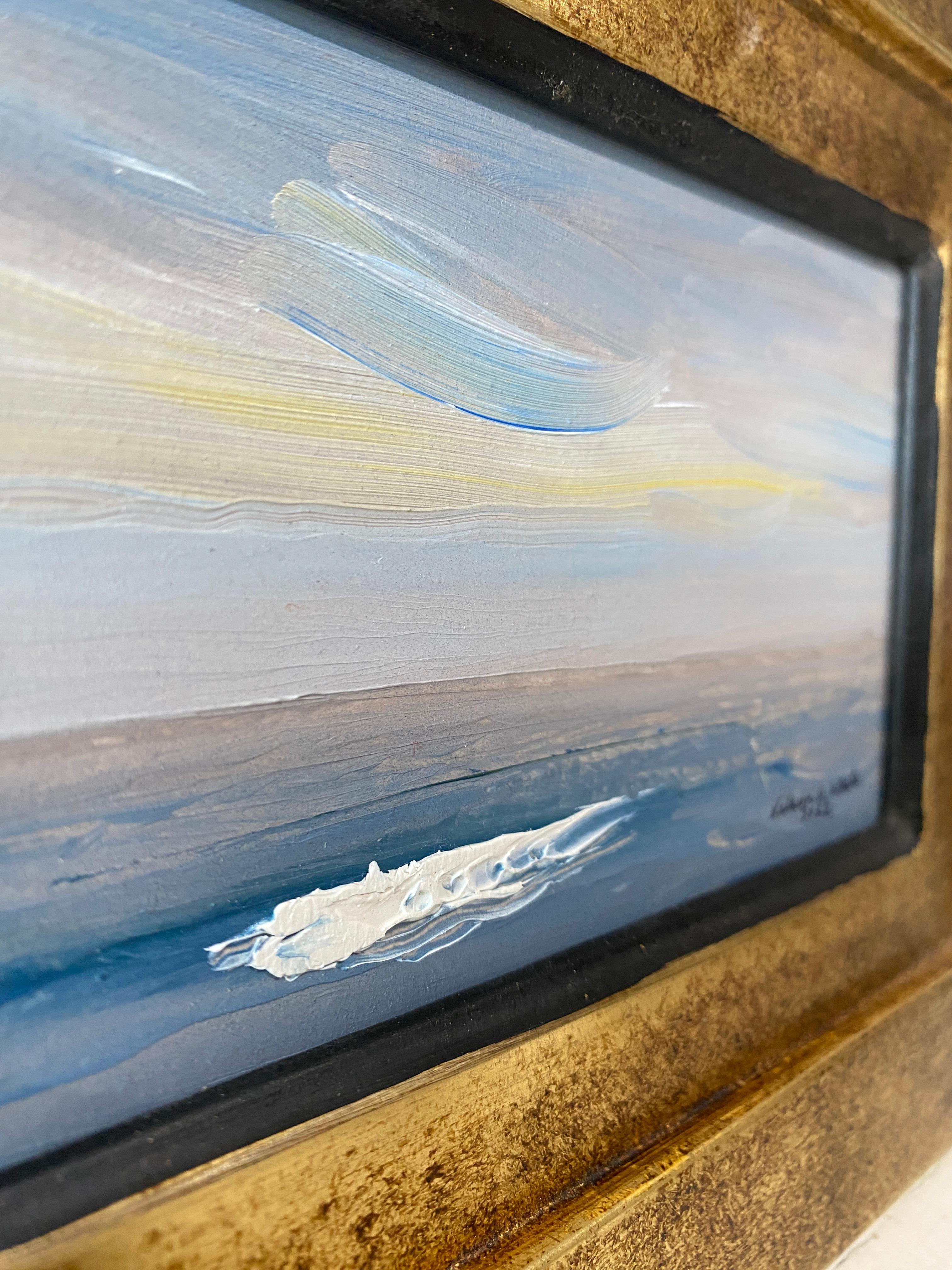 A serene plein air painting from Nelson White, featuring his recognizable impasto whitecaps. A deep blue sea meets a lilac-brown horizon, and ascends back into the blue sky, adorned with yellow light. 

Framed in a custom italian frame - bronze leaf