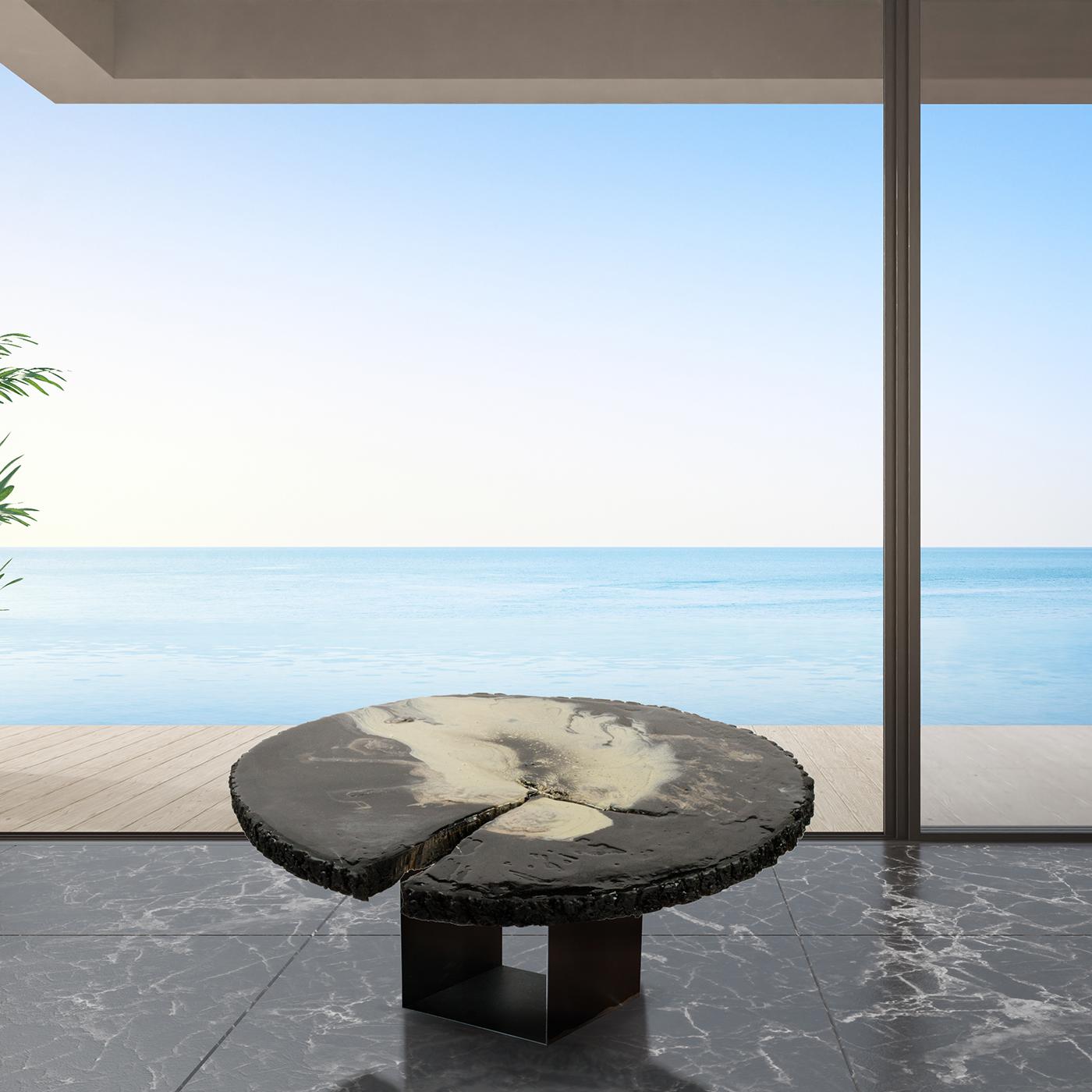 From the ROU Materiaal Nubi collection, the Nembo Lo Scuro coffee table offers otherworldly style made from organic elements. On an iron base, the table is made with a cross section of a cedar tree, worked with resins and acrylics for a unique