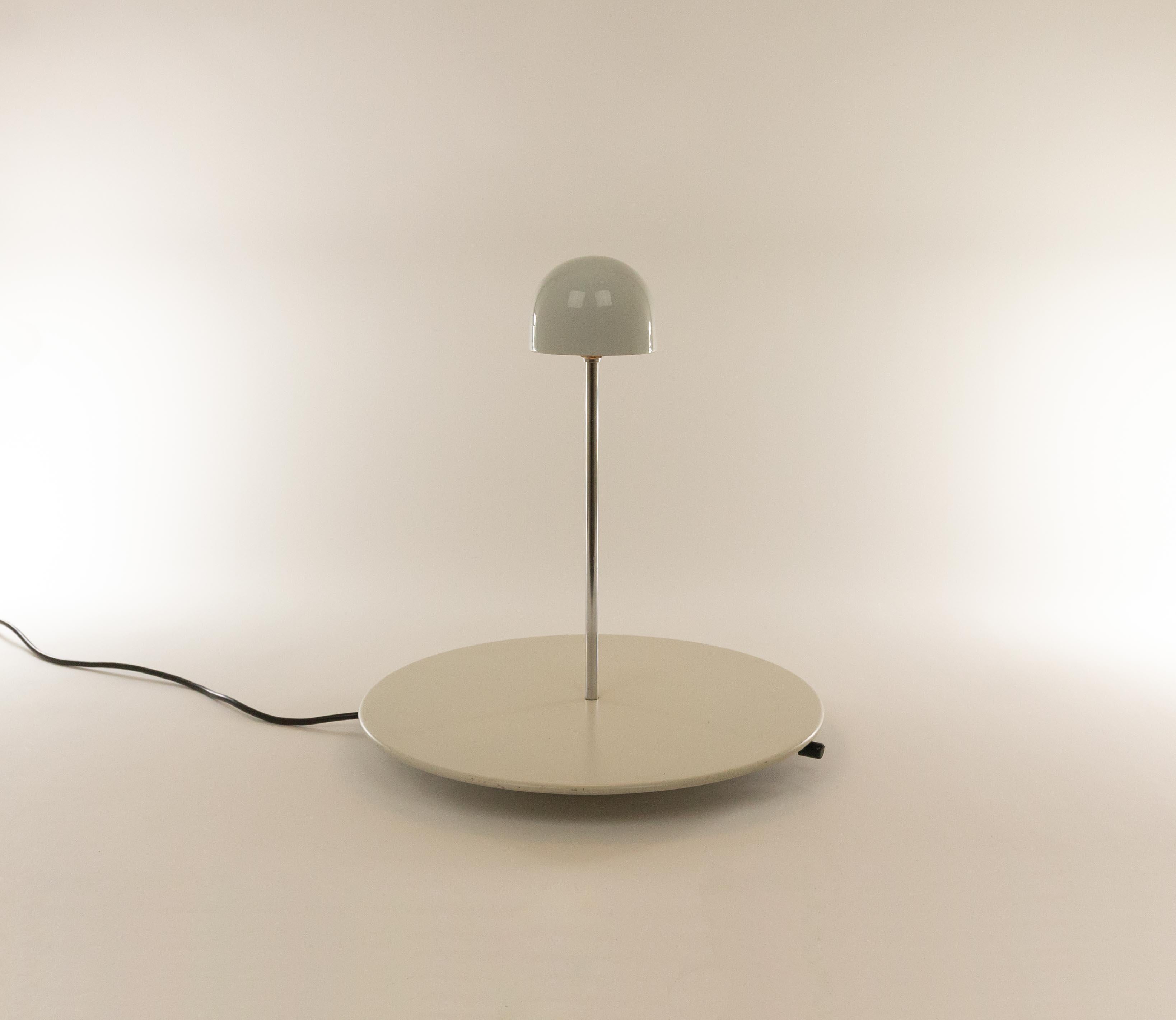 Nemea halogen table lamp by Vico Magistretti and produced by Artemide.

Magistretti designed Nemea in 1979. It consists of a round base, with a chrome tube and a hemisphere mounted on it. The halogen lamp is incorporated in this hemisphere; the