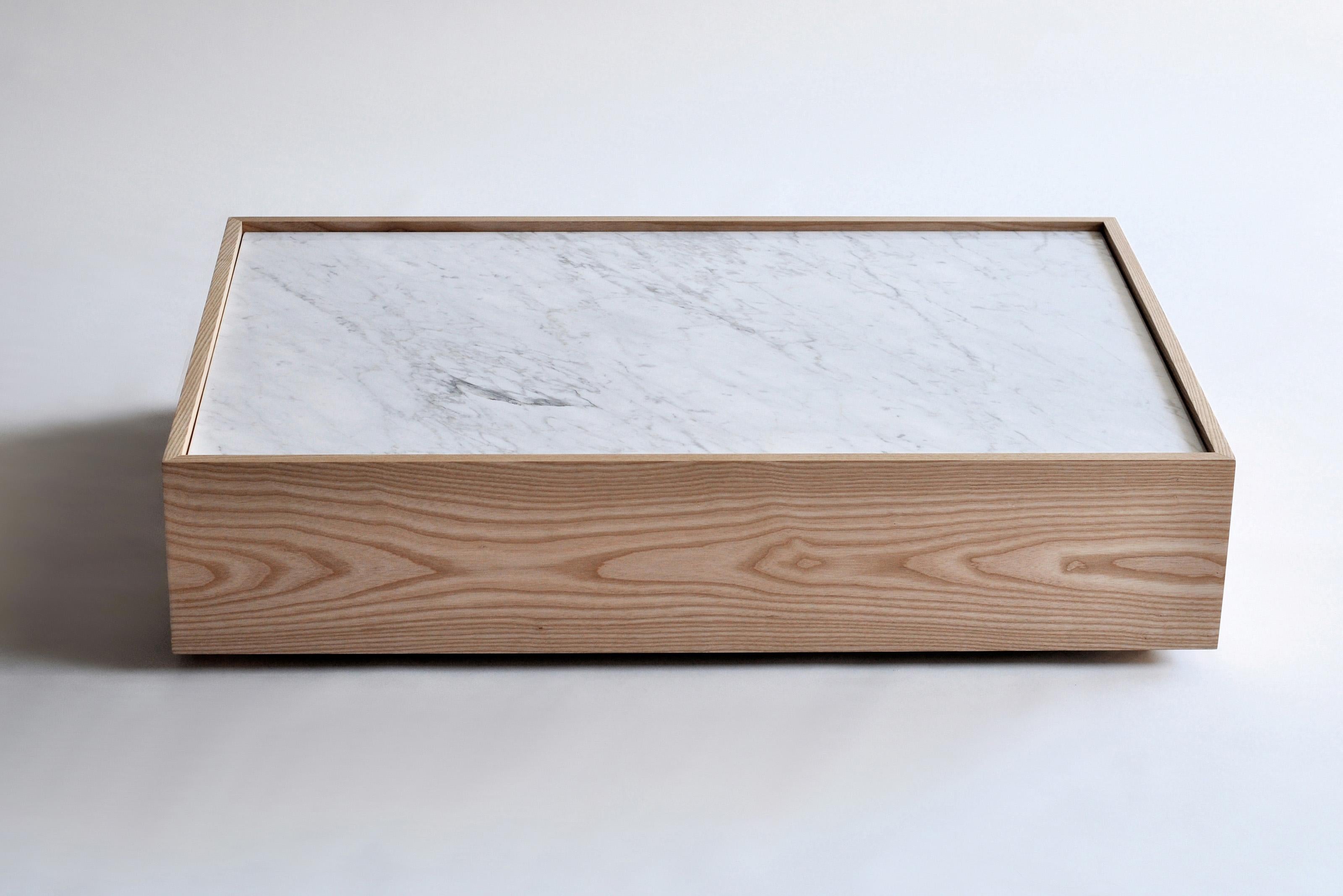 Nemesis Version A Coffee Table by Phase Design
Dimensions: D 76.2 x W 114.3 x H 25.4 cm. 
Materials: Carrara marble and white ash.

Solid walnut, white ash, white oak, or ebonized oak, available in all wood construction with or without white Carrara
