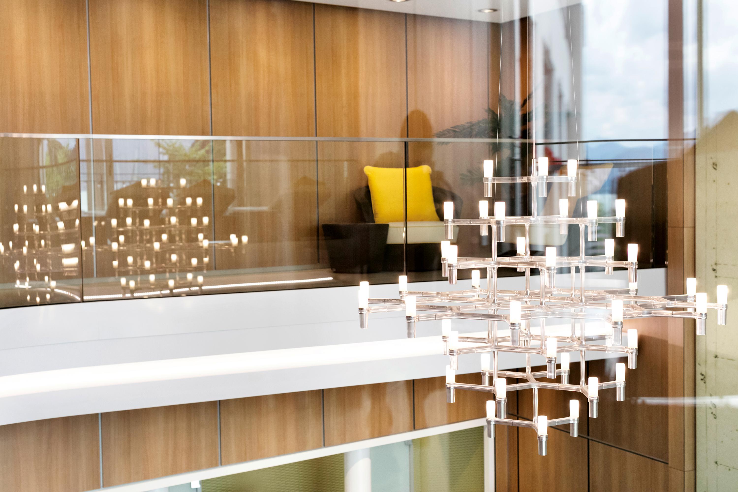 Family of pendant chandeliers, wall and floor lamps, with modular structure in die-casted aluminum and sandblasted glass diffusers. Structure in hand polished aluminum, glossy gold-plated, black-plated, or painted in matt white, matt black or gold.