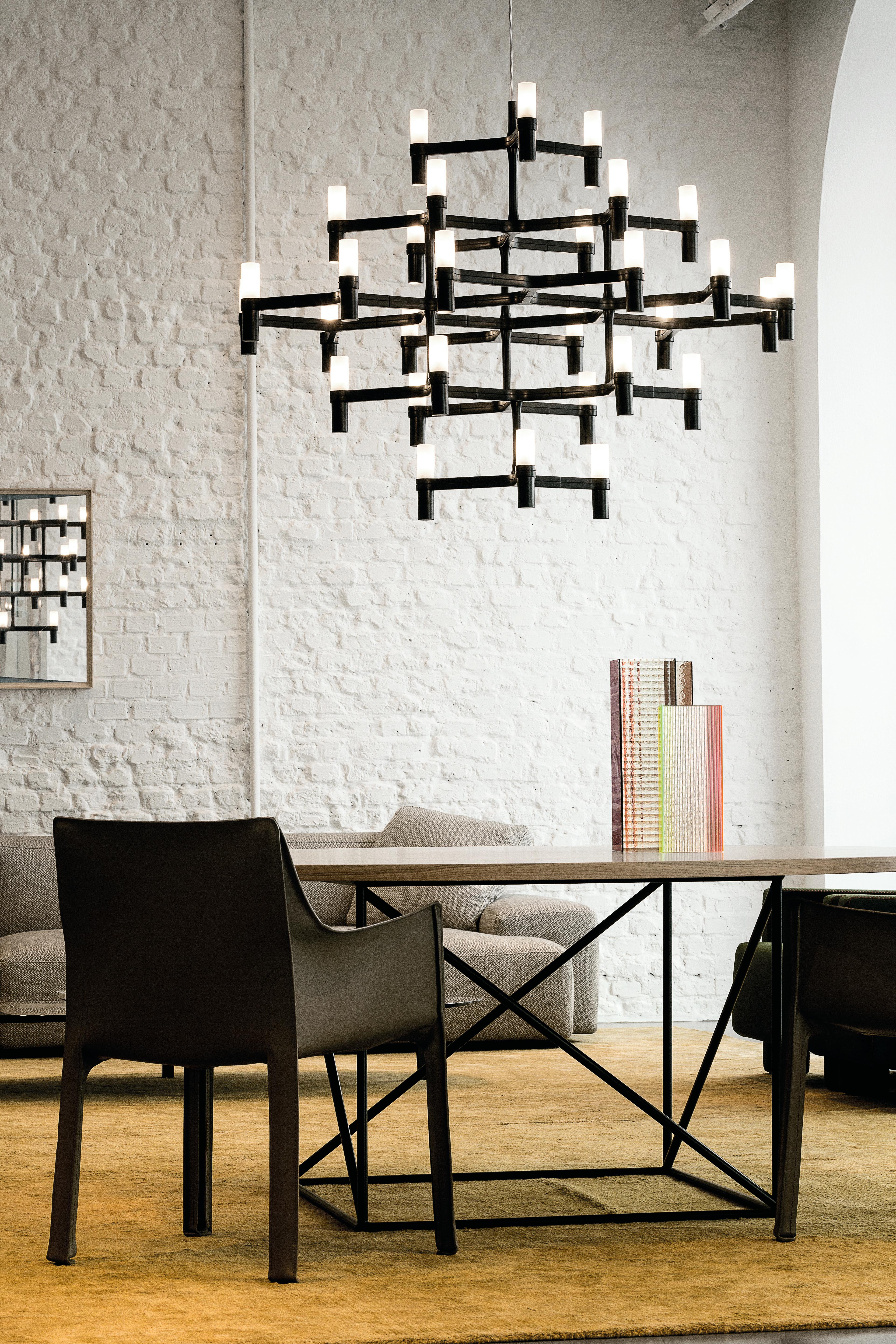 Quick ship options: black or polished aluminum 

Pendant chandelier whose shape is inspired by the outline of the snow crystal. Modular lamps with a die-casted aluminum structure and sandblasted glass diffusers. Structure is available in different