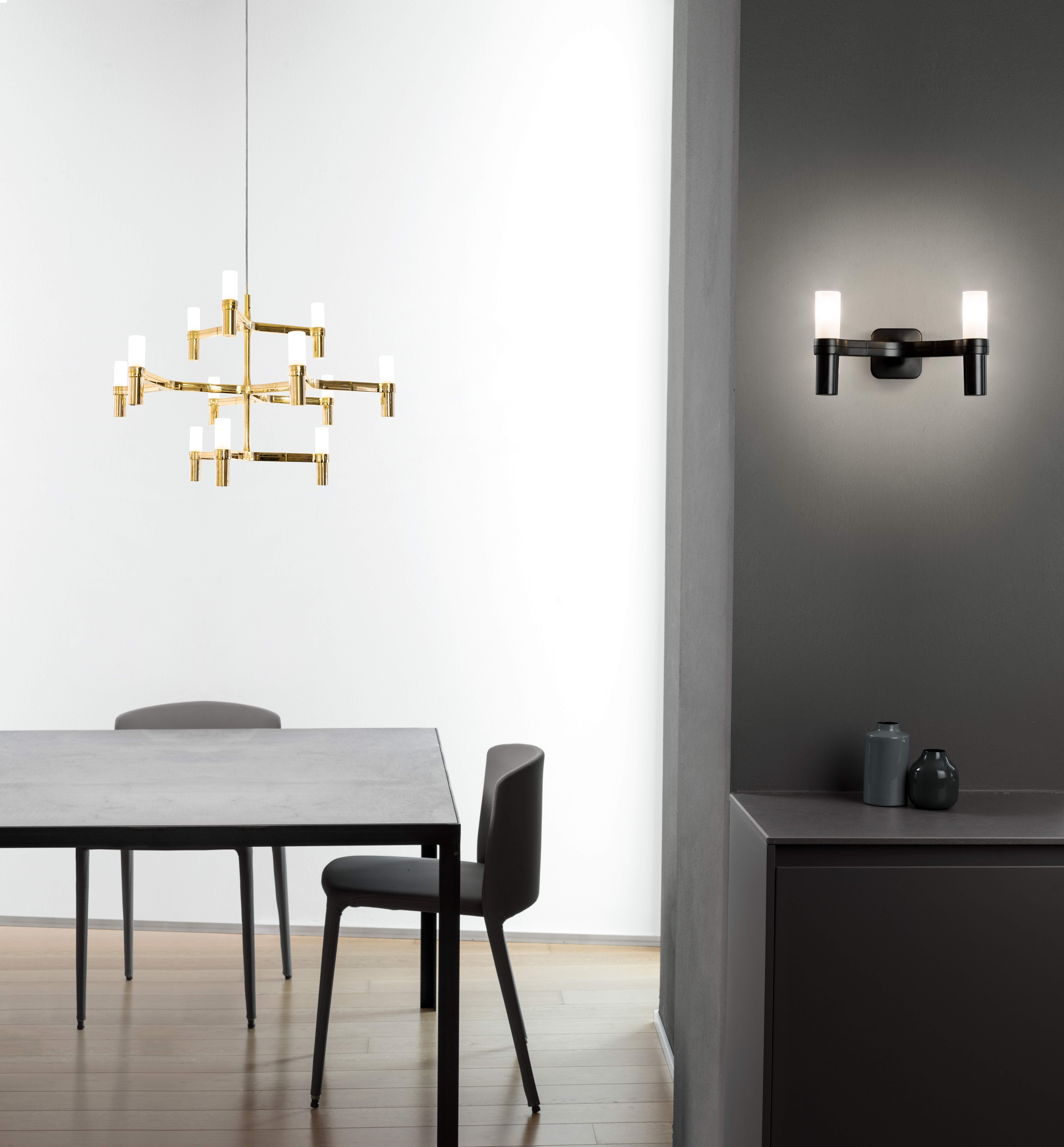 Pendant chandelier whose shape is inspired by the outline of the snow crystal. Modular lamps with a die-casted aluminum structure and sandblasted glass diffusers. Structure is available in different finishes: hand polished aluminum, glossy gold