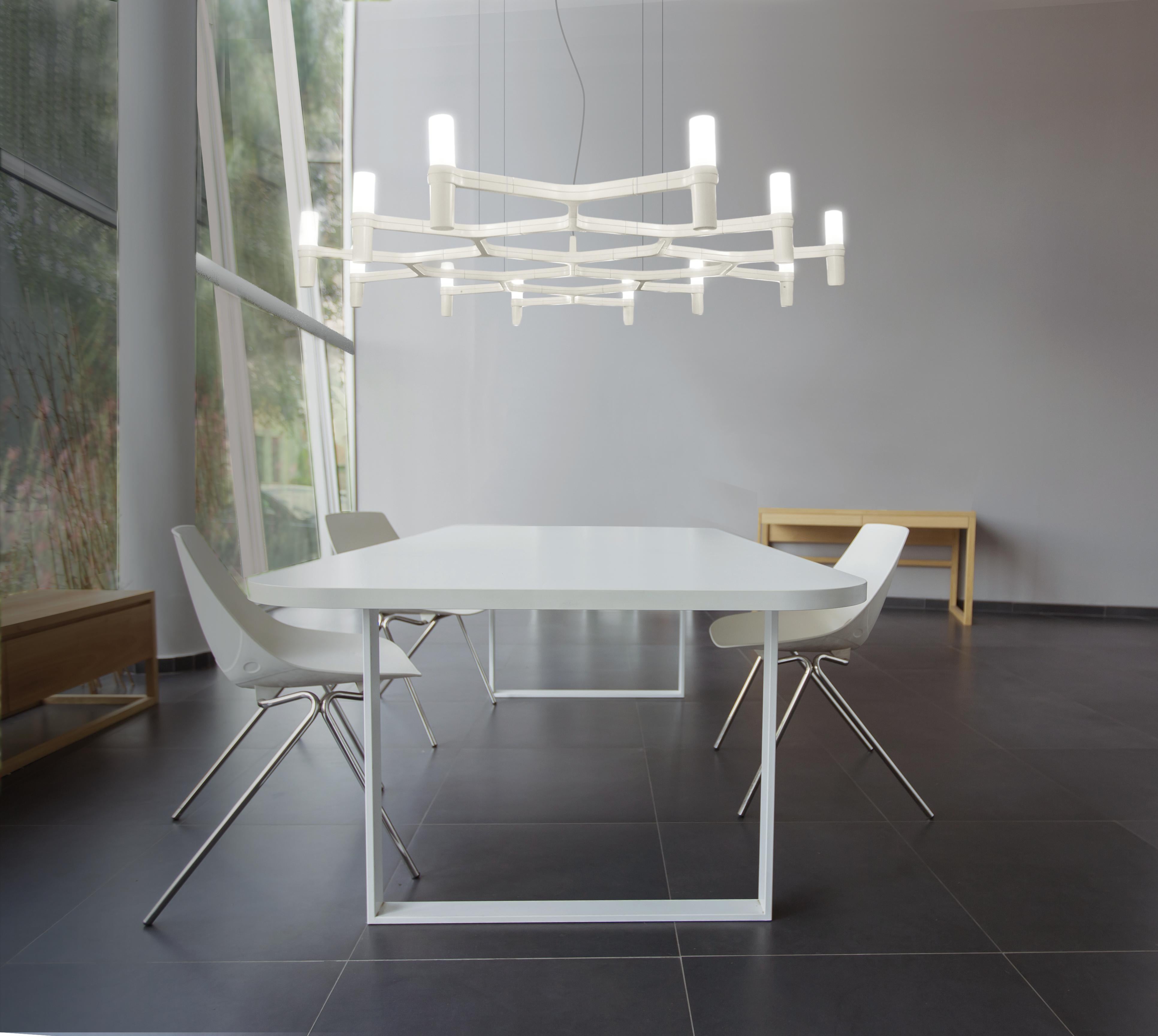 Pendant chandelier whose shape is inspired by the outline of the snow crystal. Modular lamps with a die-casted aluminum structure and sandblasted glass diffusers. Structure is available in different finishes: hand polished aluminum, glossy gold