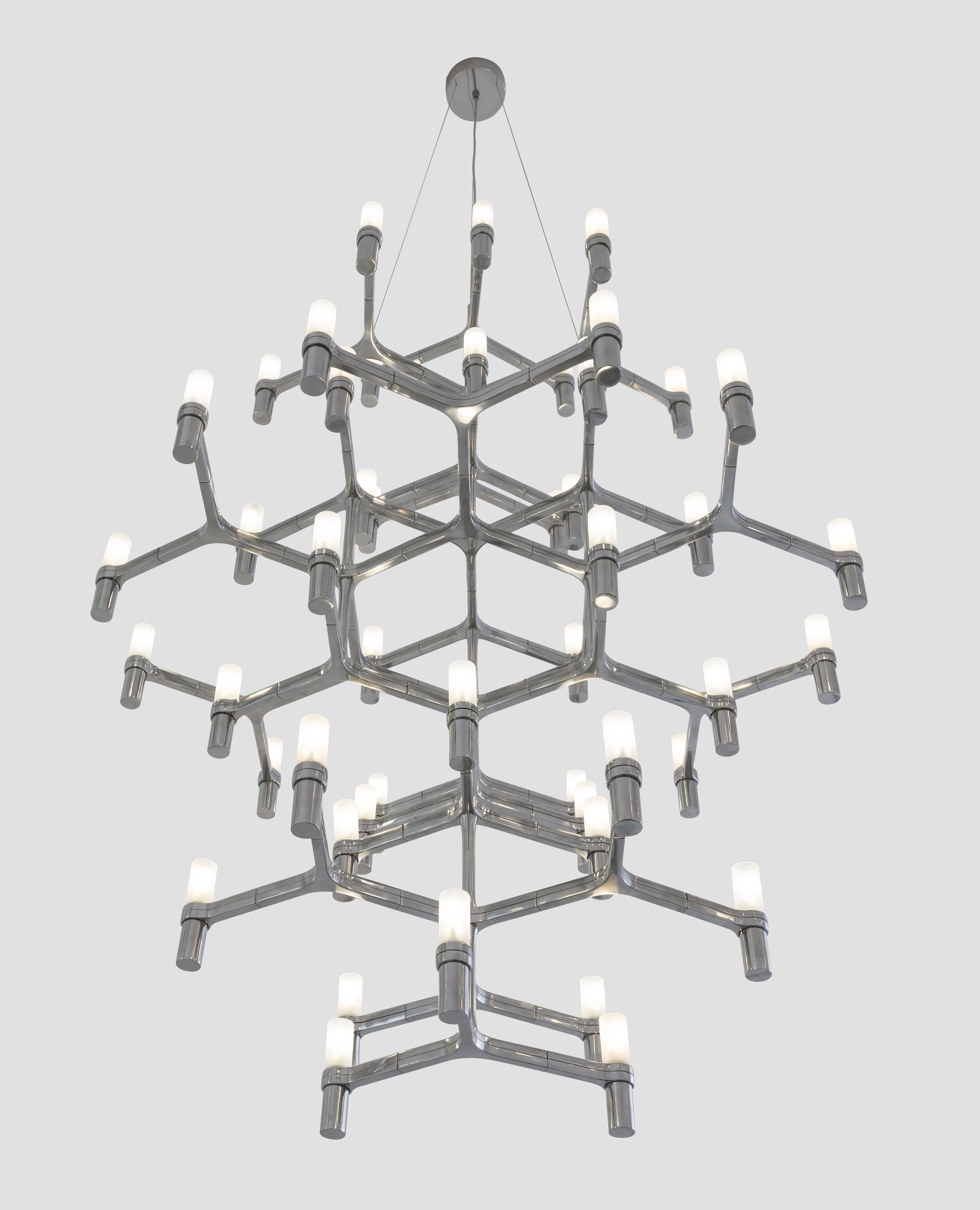 Family of pendant chandeliers, wall and floor lamps, with modular structure in die-casted aluminum and sandblasted glass diffusers. Structure in hand polished aluminum, glossy gold plated, black plated, or painted in matt white, matt black or gold.