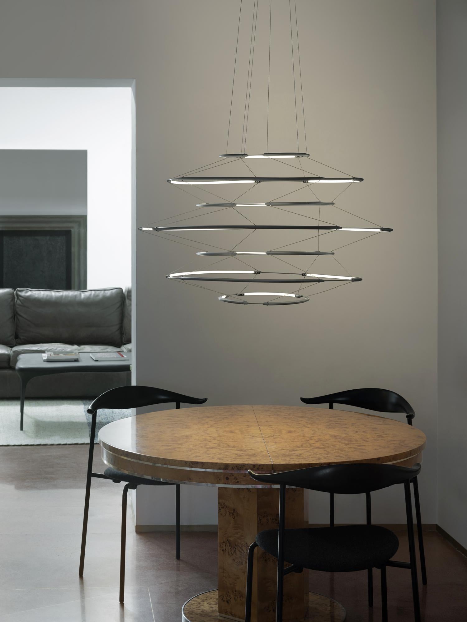 Instinct and constant design diligence in a collection that is the outcome of a sophisticated lighting engineering. A clear lines chandelier combined with an extremely slim aluminium structure for a soft echo of strong and diffused light. Each