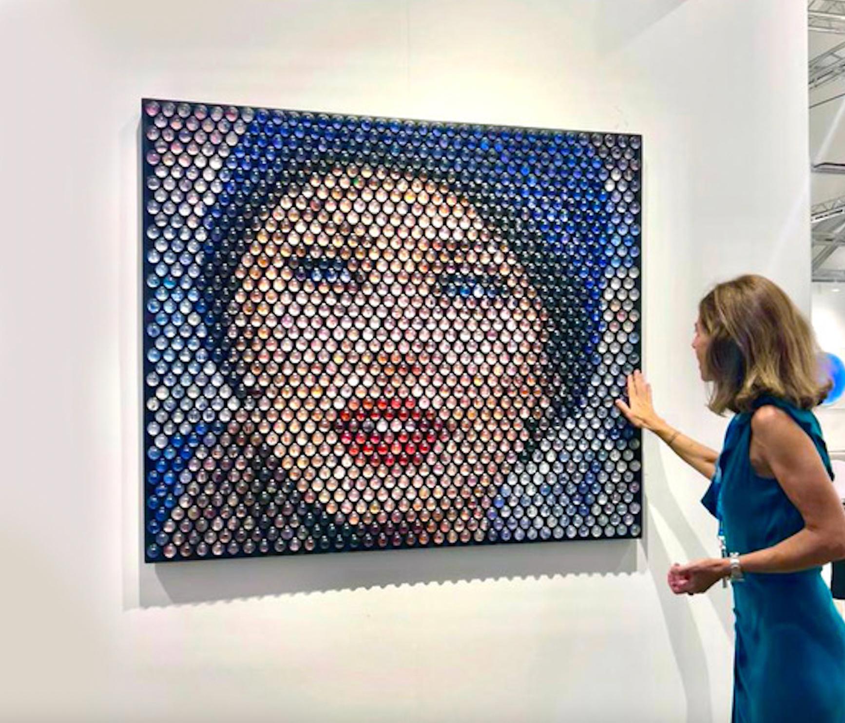 In the latest series, inspired by media, pop culture, and film Jantzen takes Neo-pointillism to the next level utilizing thousands collection of photography, cinematographic stills, and other collected material encapsulated in glass spheres; hiding
