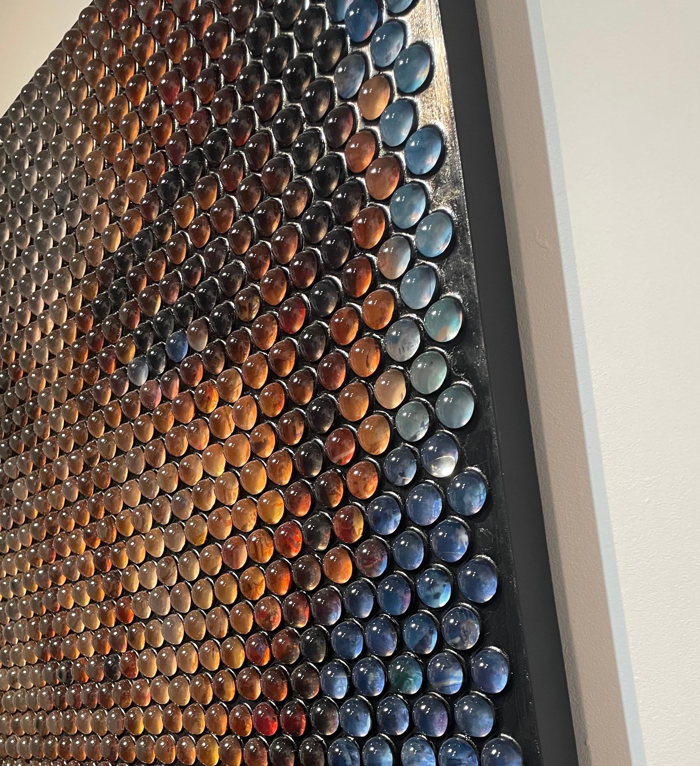 In the latest series, inspired by media, pop culture, and film Jantzen takes Neo-pointillism to the next level utilizing thousands collection of photography, cinematographic stills, and other collected material encapsulated in glass spheres; hiding