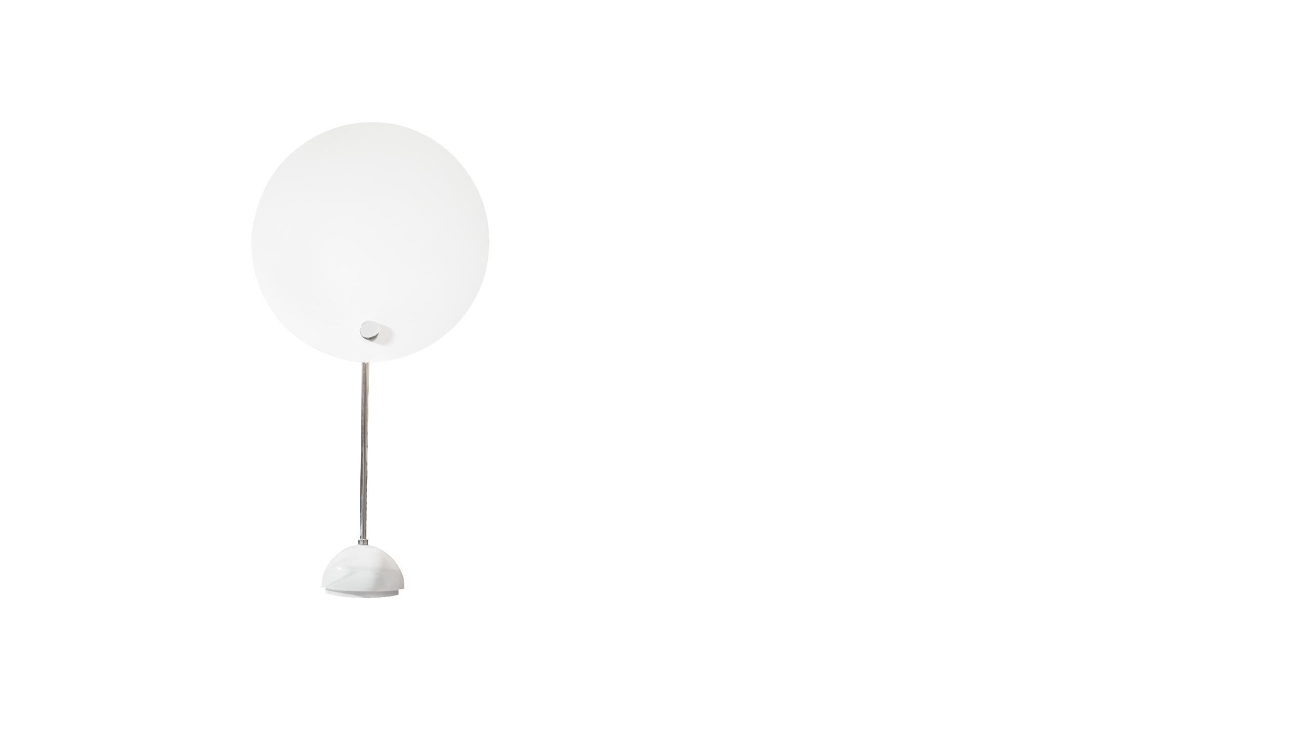 KUTA table
Table lamp with an aluminum circular reflector which shields the lighting distribution, giving the effect of a solar eclipse. The circular screen is painted in white and black, the stem and the metal small parts and hemispherical support