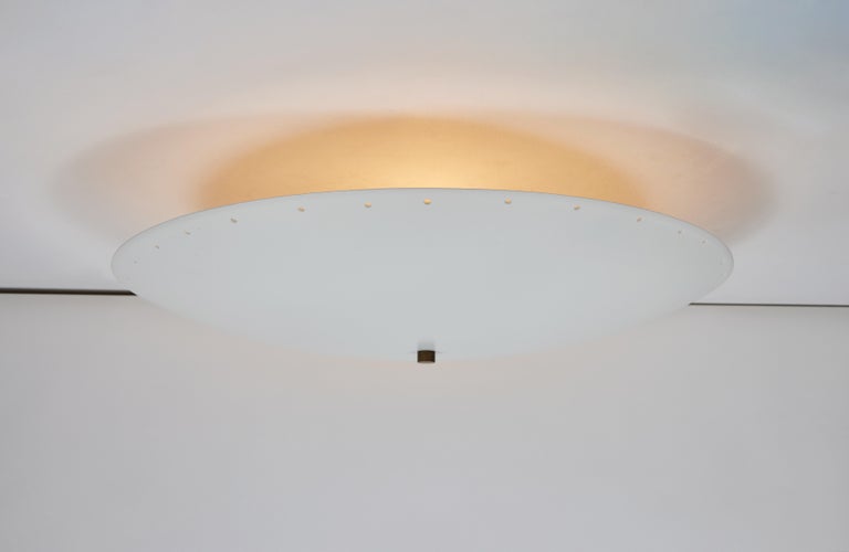 'Nena' perforated dome ceiling lamp by Alvaro Benitez. Hand-fabricated by Los Angeles based designer and lighting professional Alvaro Benitez, these highly refined table lamps are reminiscent of the iconic midcentury Italian designs of Arteluce and