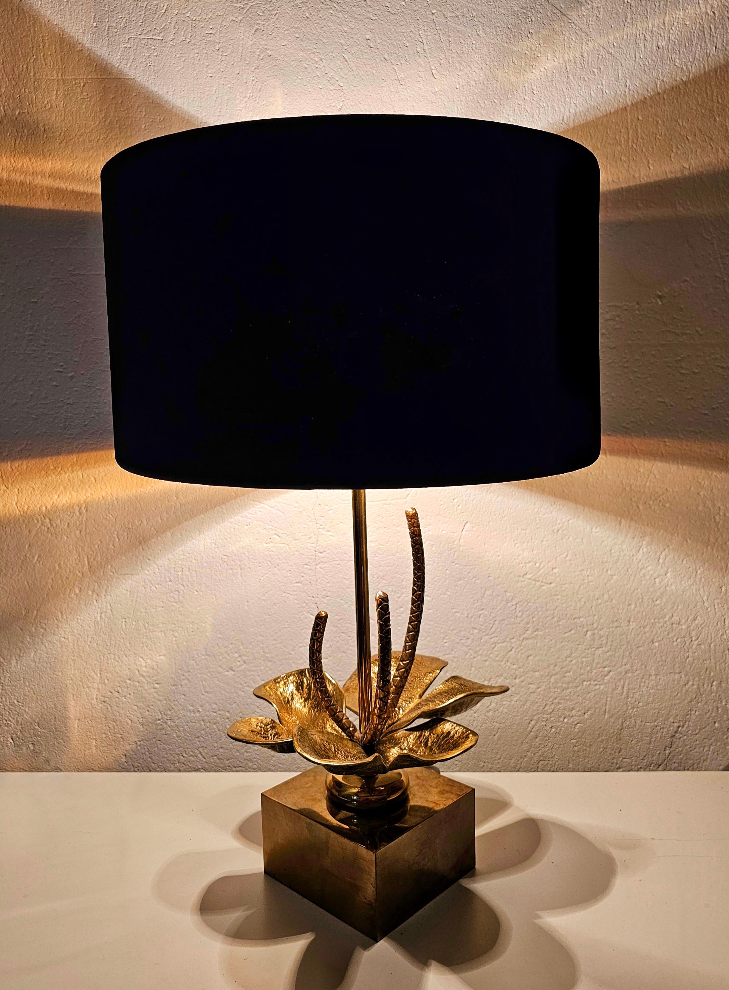In this listing you will find an eye-catching Mid Century Modern table lamp featuring Nenuphar Lilly done in bronze and brass and manufactured by Maison Charles. It features black velvet shade with golden sheet inside which provides gorgeous golden
