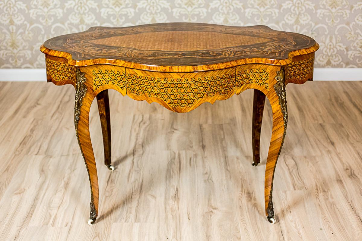 We present you this piece of furniture from the second half of the 19th century, in the neo-Baroque style. The wavily shaped top and the apron are supported on cabriole legs that end with porcelain spheres. There is a spacious drawer on one side of