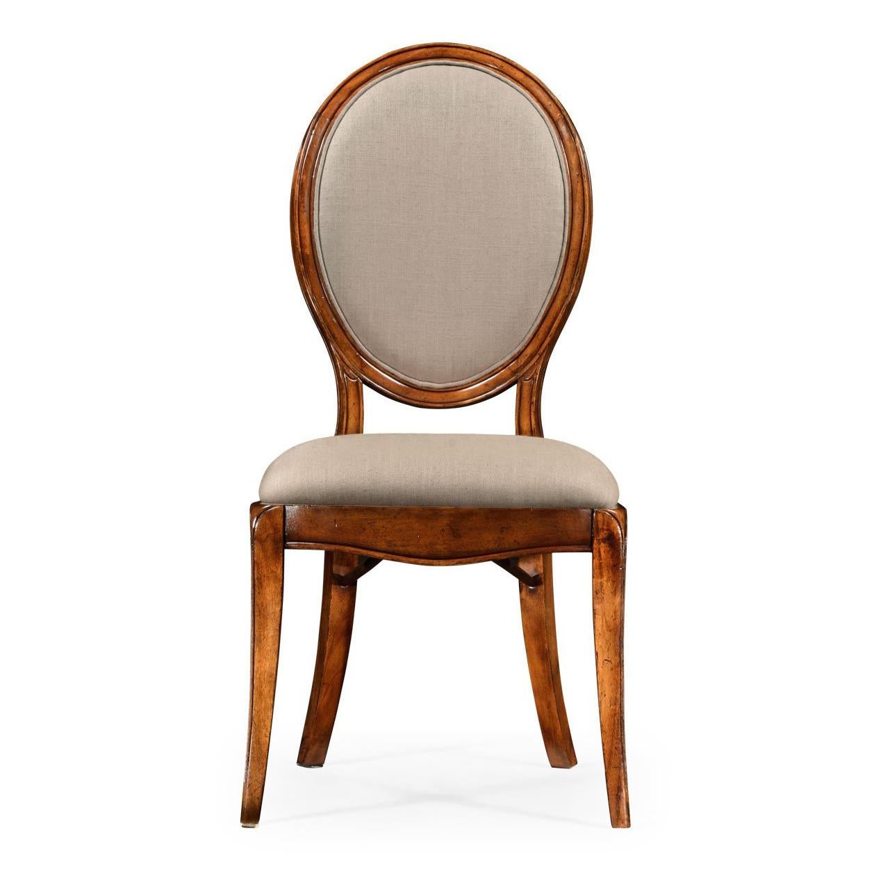 A spoon back walnut dining chair with simple molding to the frame, neutrally upholstered seat and curved back panel, and serpentine front rail. Tapering curved legs to the front and raked legs to the rear. The original of circa 1790.

Dimensions: