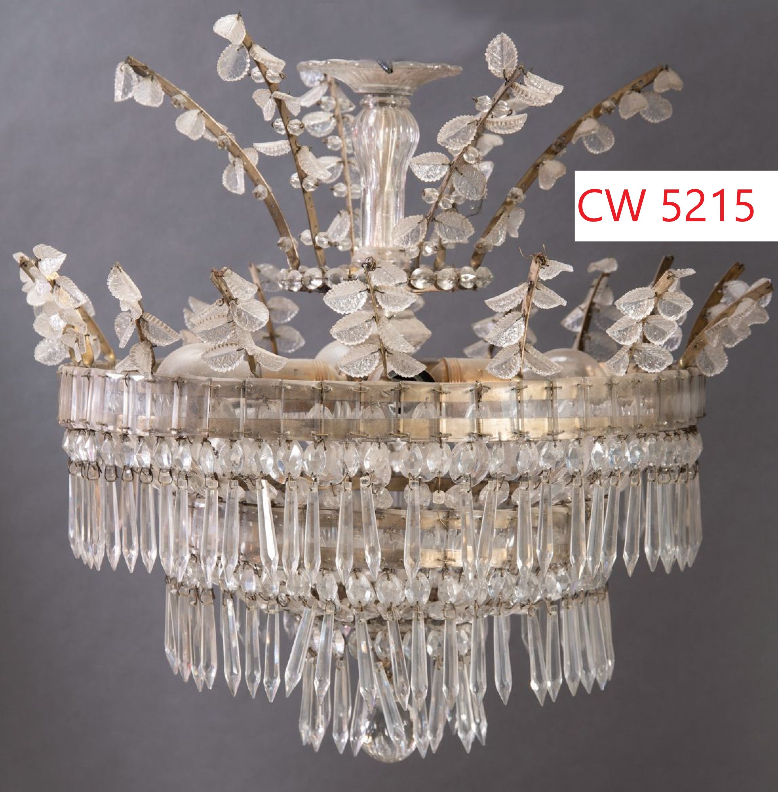 A very fine neo classical Chandelier featuring protruding branches ornate with pressed glass leaves. On the bottom concentric cascades of U-drops. 
CW5215.