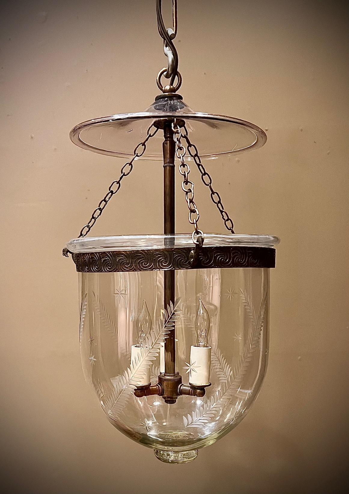 This Regency hand-blown and etched bell jar lantern is the perfect addition to any room  in any decor -- from contemporary, to eclectic, to traditional. A must-have in the foyer, kitchen, breakfast room, or powder room. The fern-frond -and-star
