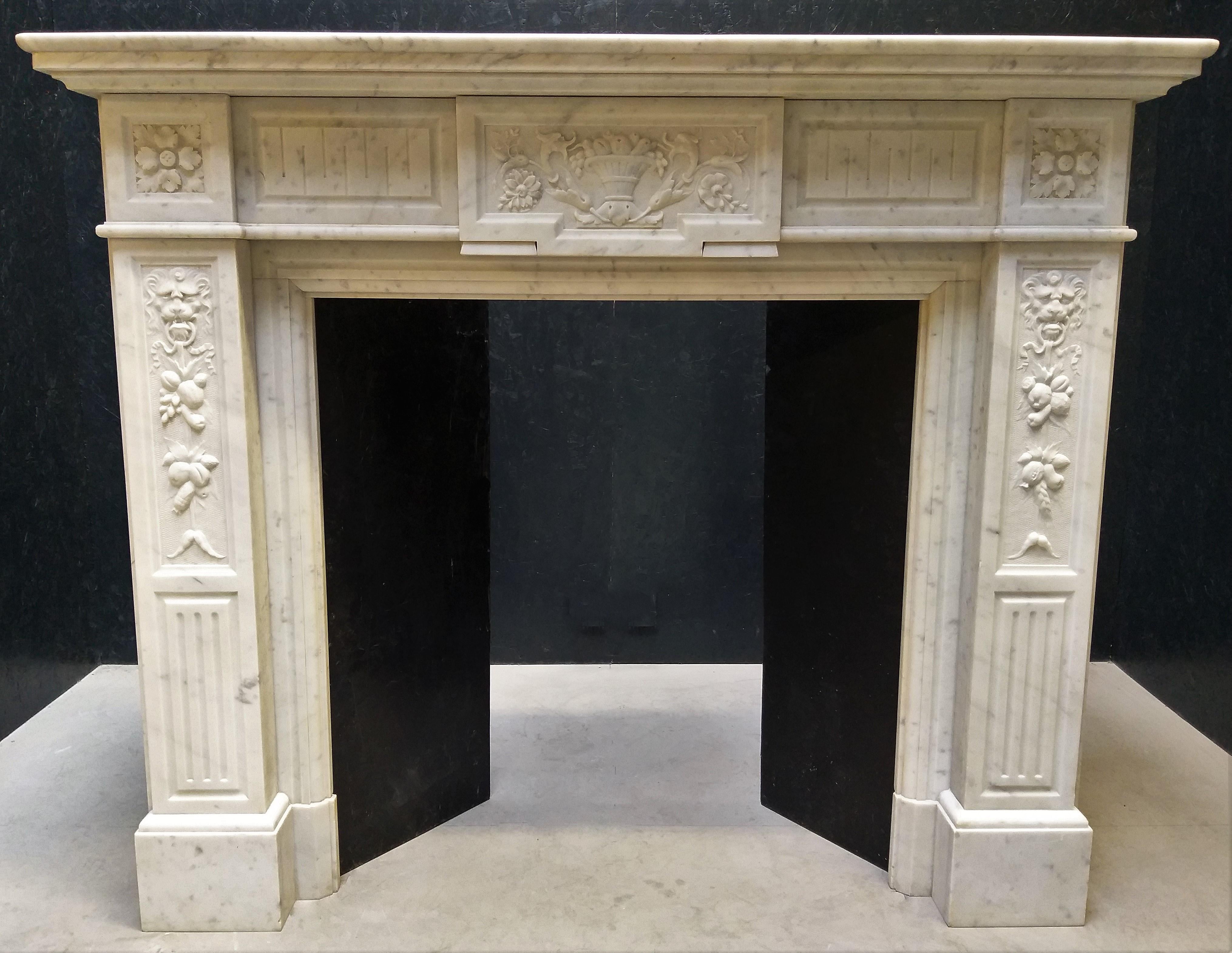 This neo-classical, white marble fireplace has the simplicity of Louis XVI lines with several Renaissance motifs. The various ornamentation all-over the front and jambs are very typical for the second half of the 19th century. The frieze and jambs