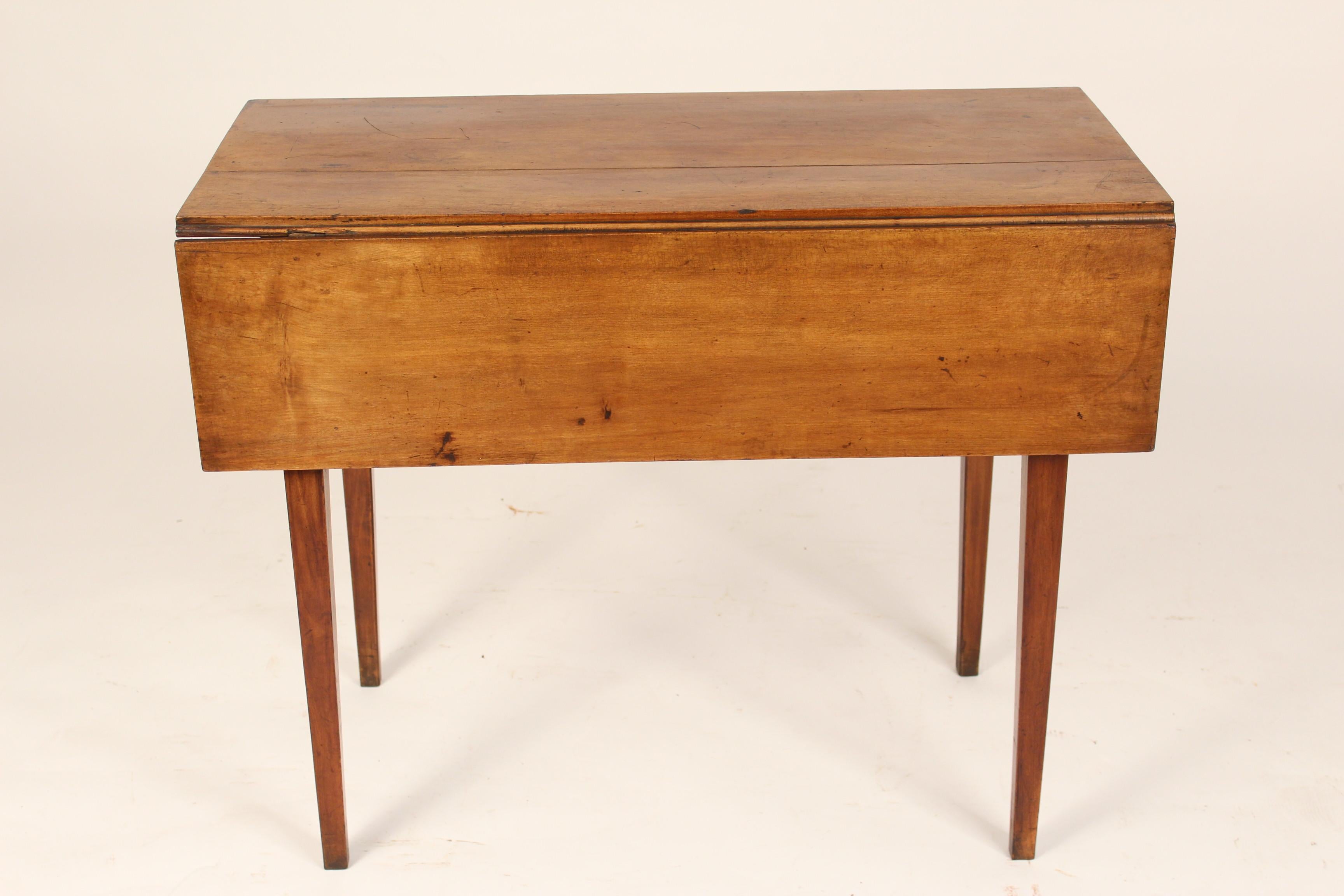 American neo classical fruit wood drop leaf table, circa 1810. Nice old fruit wood color. A versatile table that could be used as a small dining table, games table, sofa table or lamp table. Dimensions when drop leafs are lowered, height 29.5 width