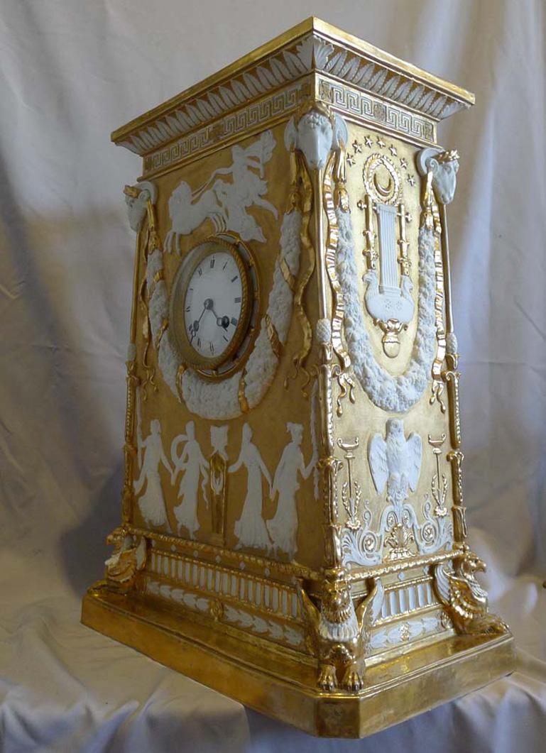 A late 19th/ early 20th century Samson bisque porcelain mantel clock, in the neo-classical style, parcel gilded with gadrooned bell top above acanthus leaf and Greek key frieze, the case decorated with Apollo and Graces with ram's heads and floral