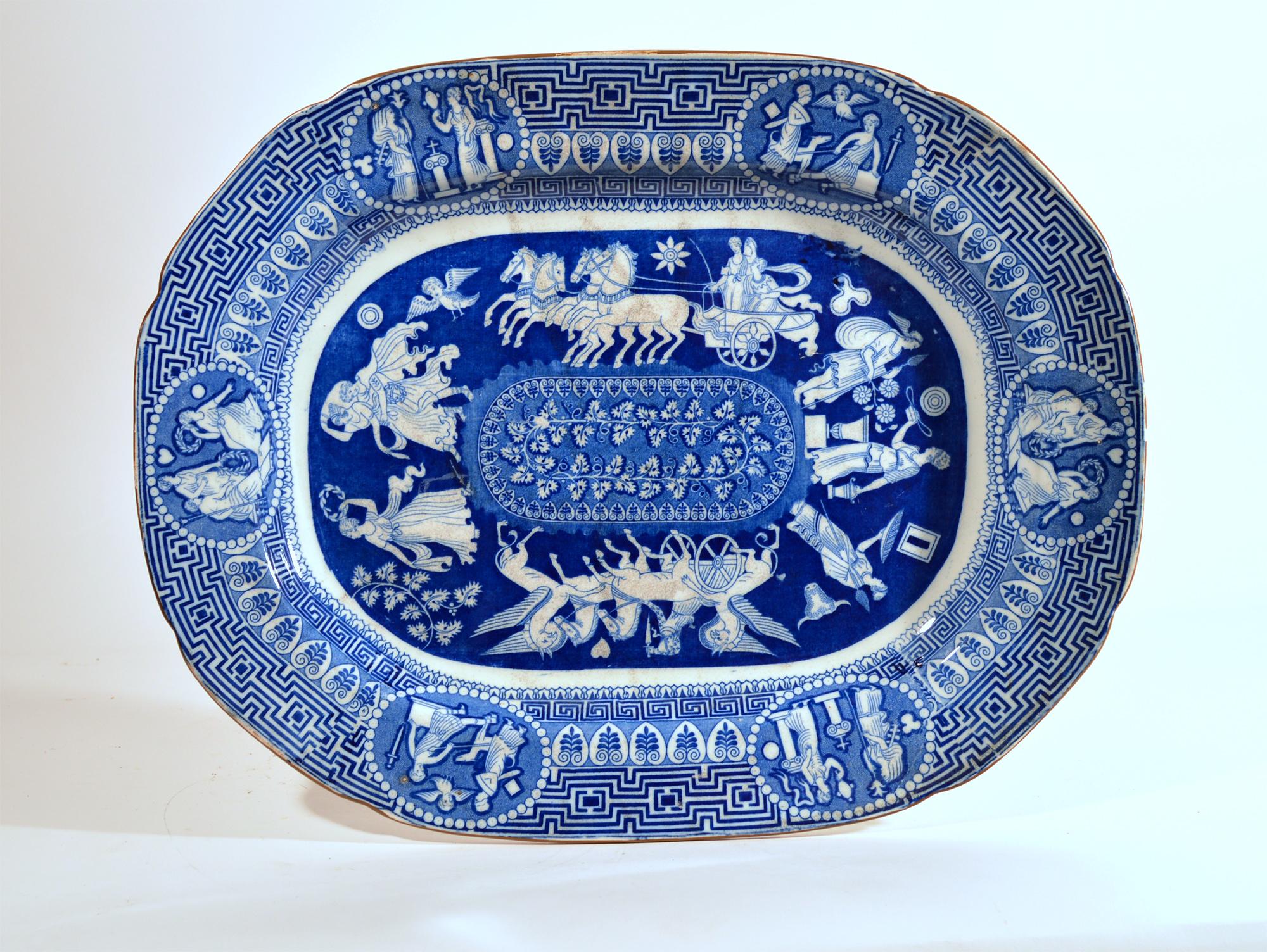 Neoclassical Greek pattern blue printed large dish,
Herculaneum, Liverpool,
Early 19th century

The Herculaneum pottery underglaze blue central pattern shows a series of images encircling an oval panel with a leafy vine. There are two main