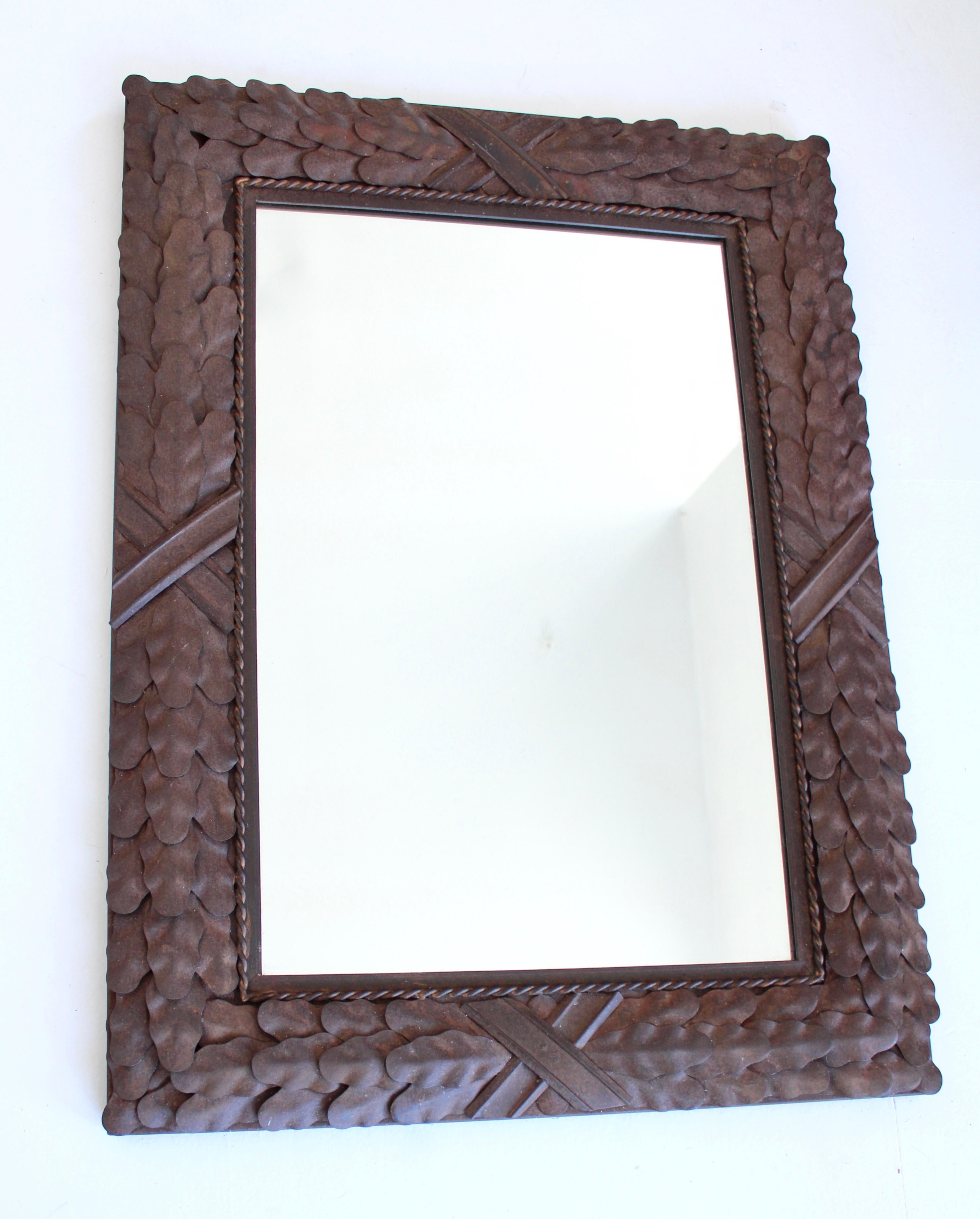 Neo classical iron Italian rusted patina mirror. Acanthus leaf details on the border with rope motif and large X on all four sides. Remnants of gilding remain. 
The frame is mounted to very old wood which authenticates its vintage age. 
Circa 19th
