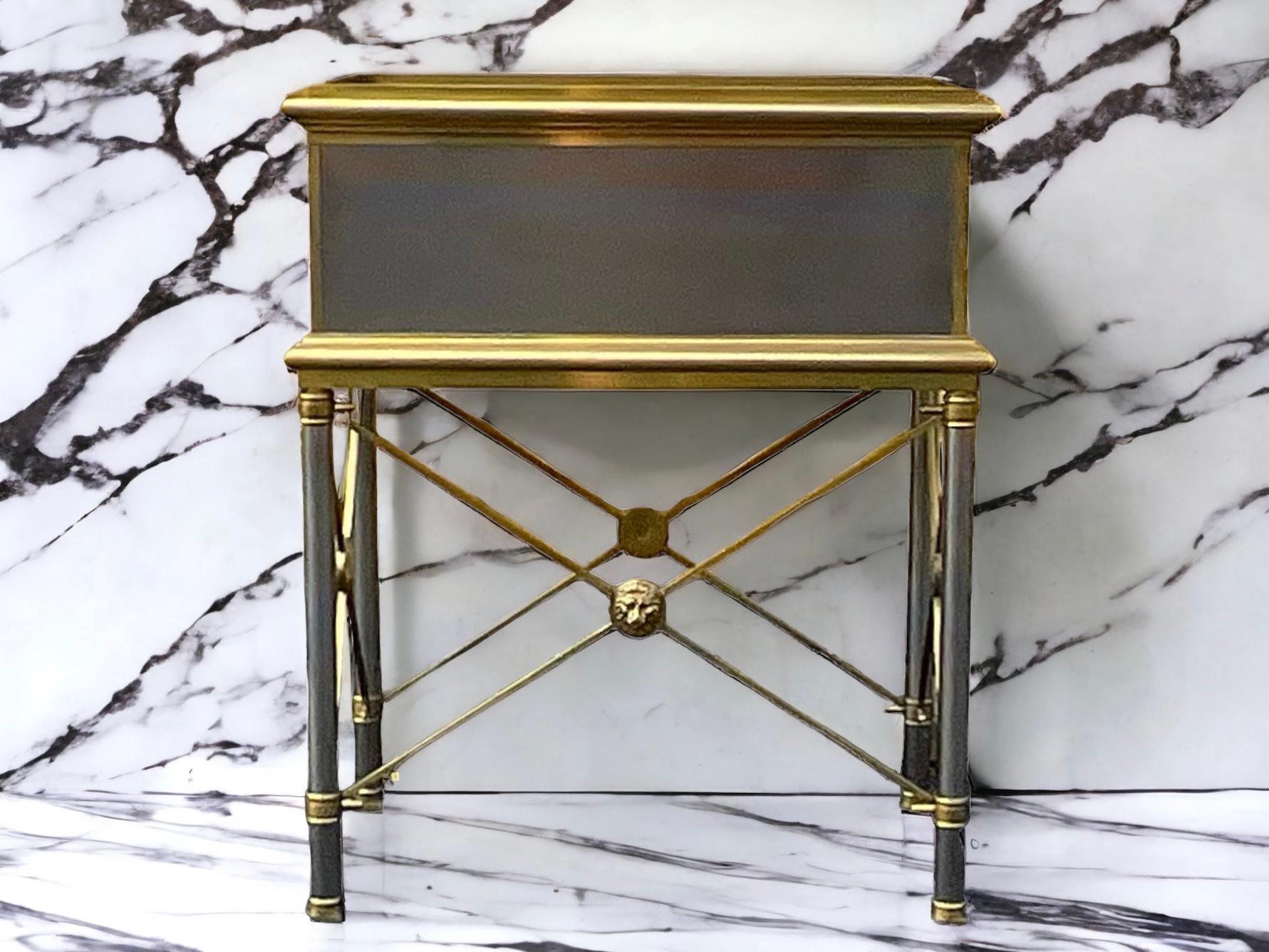 This is a handsome neo-classical Maison Jansen style stainless box on stand or side table with brass accents. The interior is velvet lined. The piece is unmarked and in very good condition.