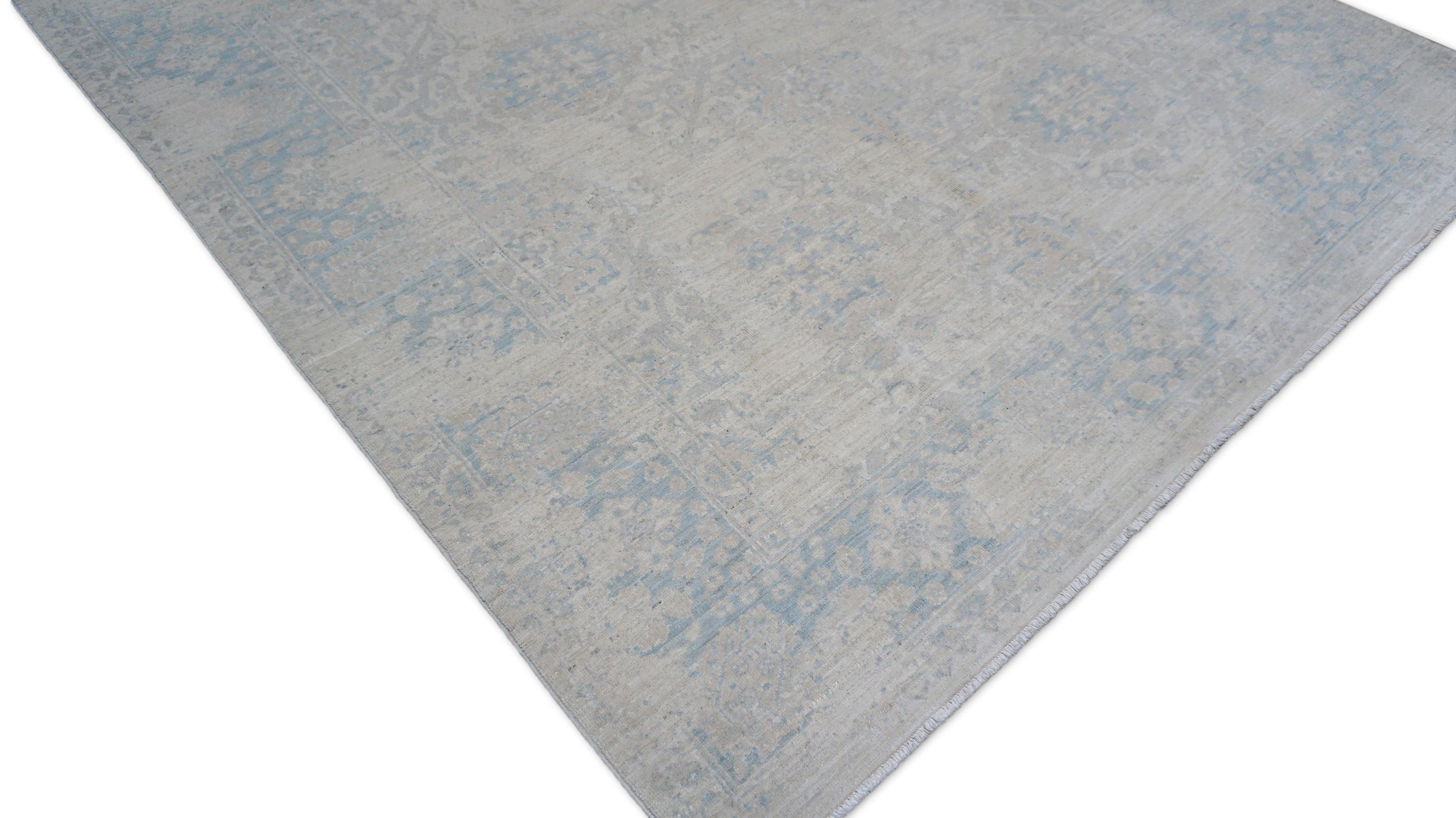 This hand-knotted wool rug showcases a refined interpretation of the classic Oushak style, characterized by its subdued elegance and softly distressed finish. Featuring a large-scale floral medallion pattern with palmettes, leafy vines, and angular