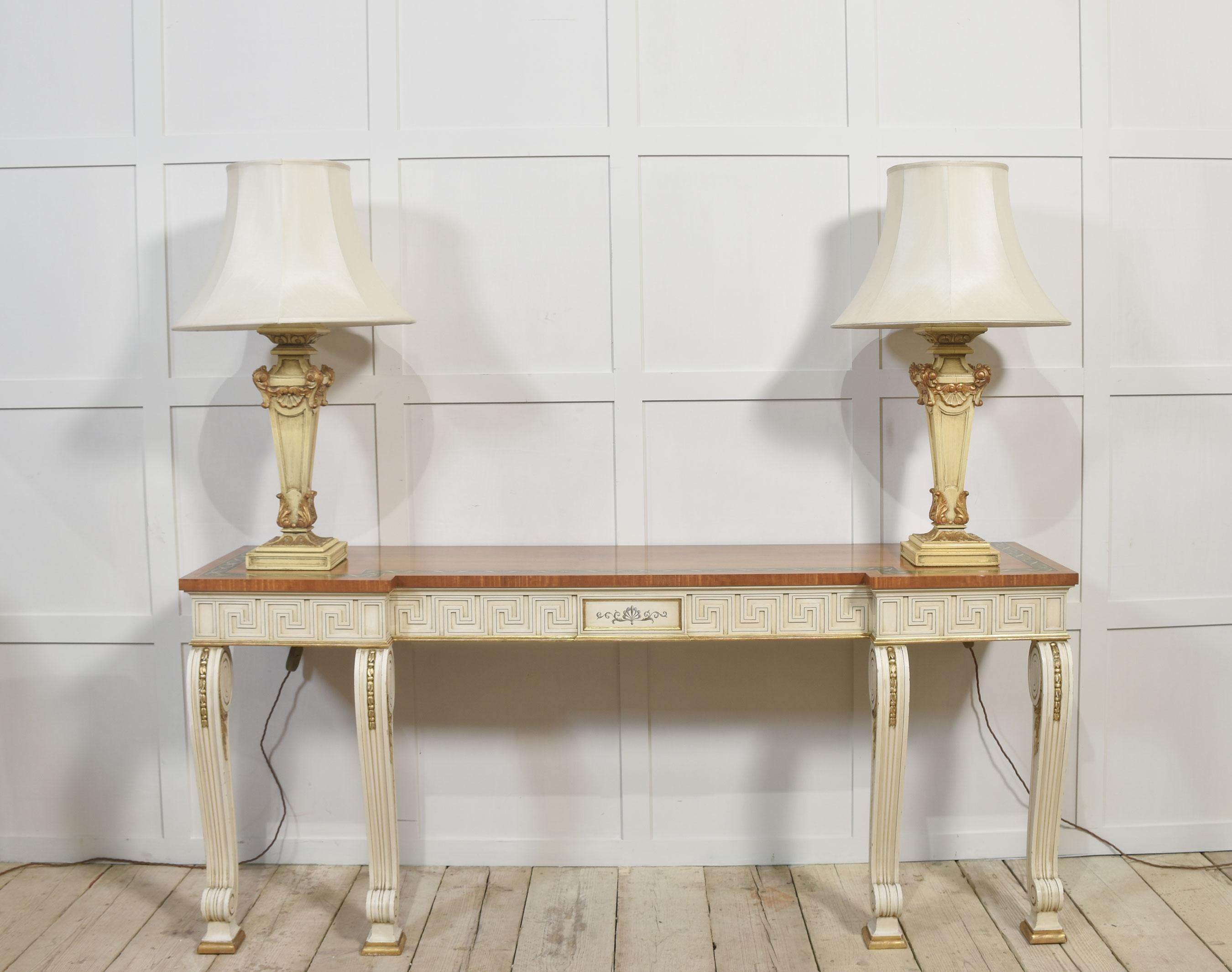 Console table, the large rectangular satinwood inverted breakfront top having a painted border. Above Greek key moulded freeze raised on cream and gilt decorated scroll supports.
Dimensions
Height 33.5 Inches
Width 78 Inches
Depth 21.5 Inches