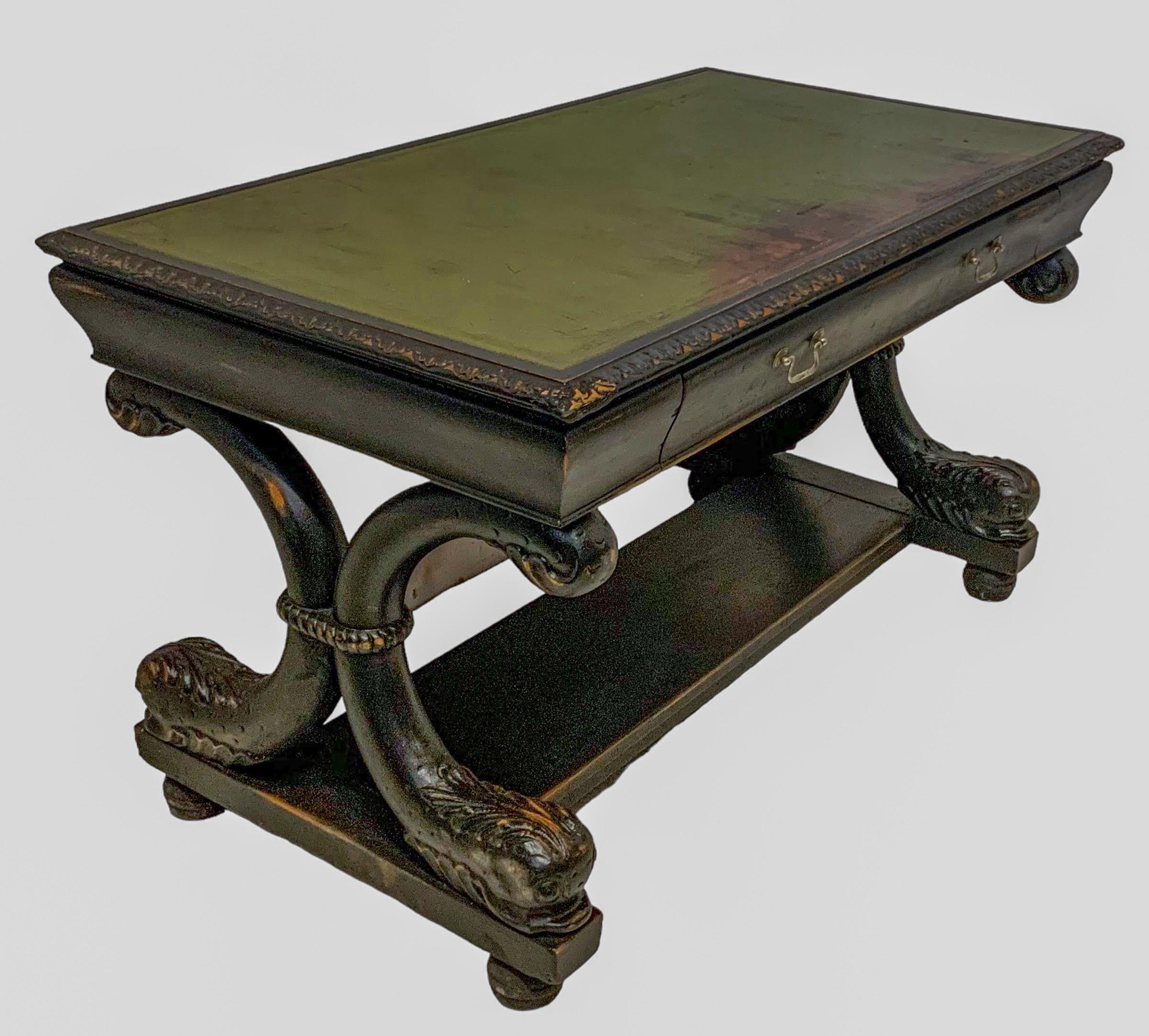 This is a late 19th century Neo-classical R.J. Horner style ebonized desk with carved dolphin base and tooled green leather top. It has wonderful patina! The desk is very heavy and most likely to be oak. It is unmarked. 