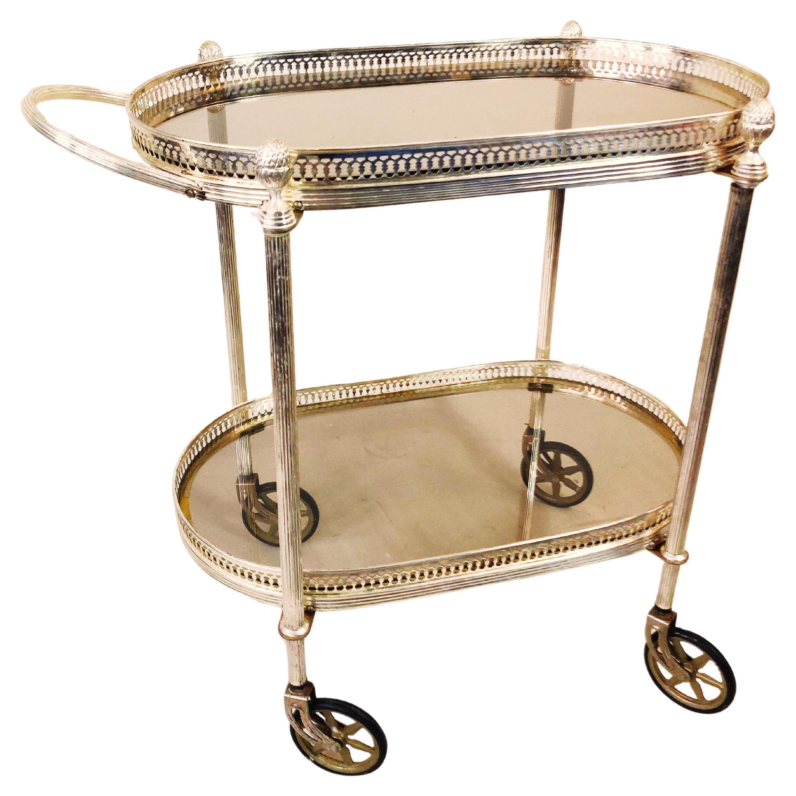 Neo classical silvered and glas drink trolley in style of Maison Jansen. For Sale