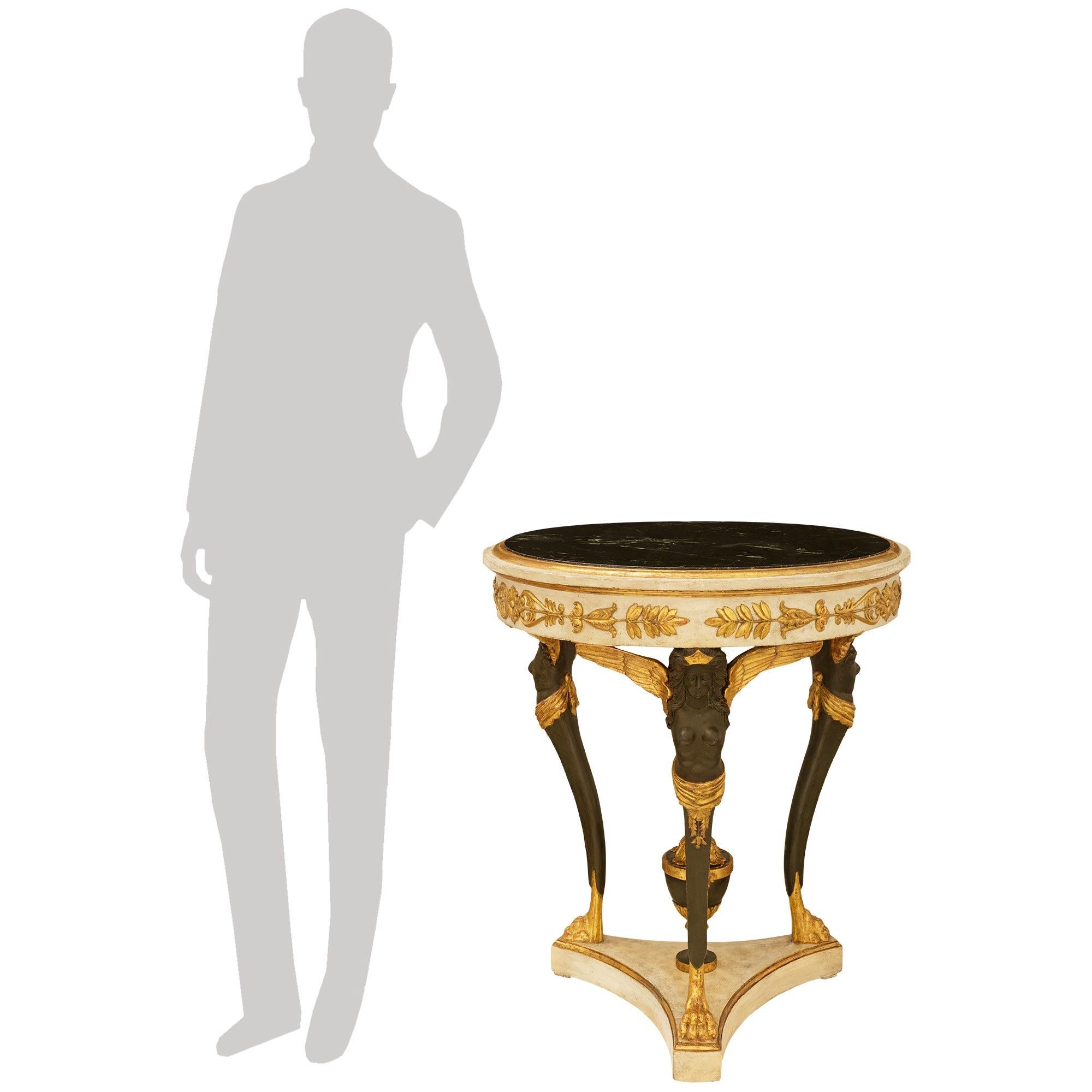 A wonderful and most decorative Italian 18th century Neo-Classical st. patinated wood, Giltwood and Verde Antico marble side table. This stunning circular table is raised on a mottled triangular patinated off white base with concave sides, and