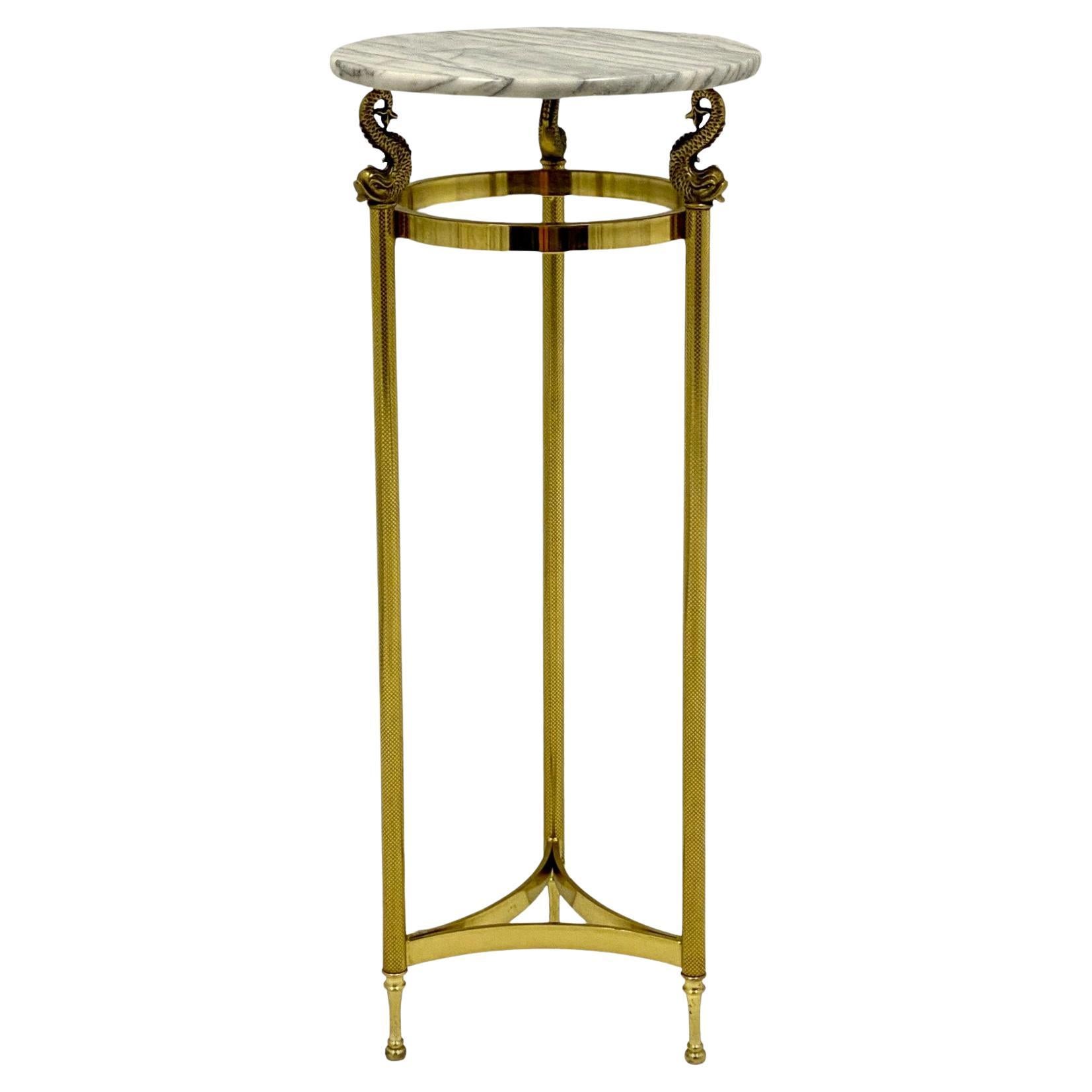 This is a timeless 1970s marble top brass pedestal with white marble top in very good condition. The top is not attached but is original. It is purported to be Italian.