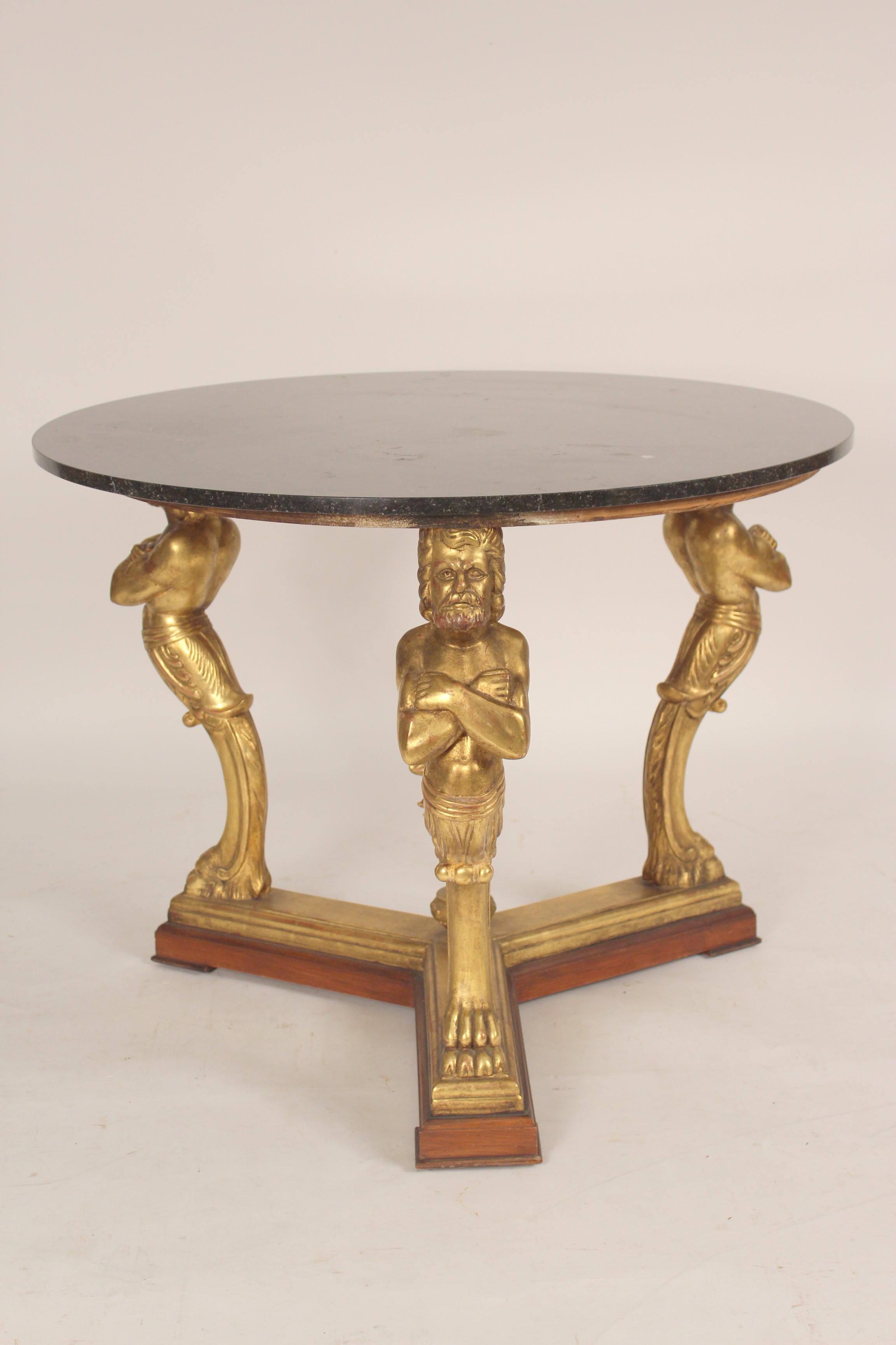 Neo classical style gilt decorated center table with a marble top, late 20th century. With carved figural supports, gold leaf decoration and a marble top.