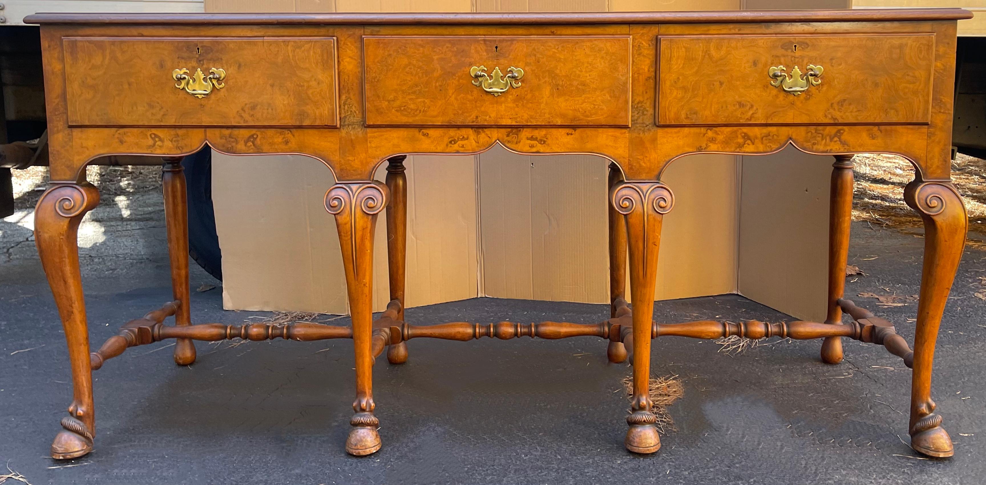 This is an exceptional piece! It is a 1950s large scale neo-classical style burl wood server or credenza. It has carved hairy paw feet and brass chippendale style hardware. It is in very good condition and unmarked.